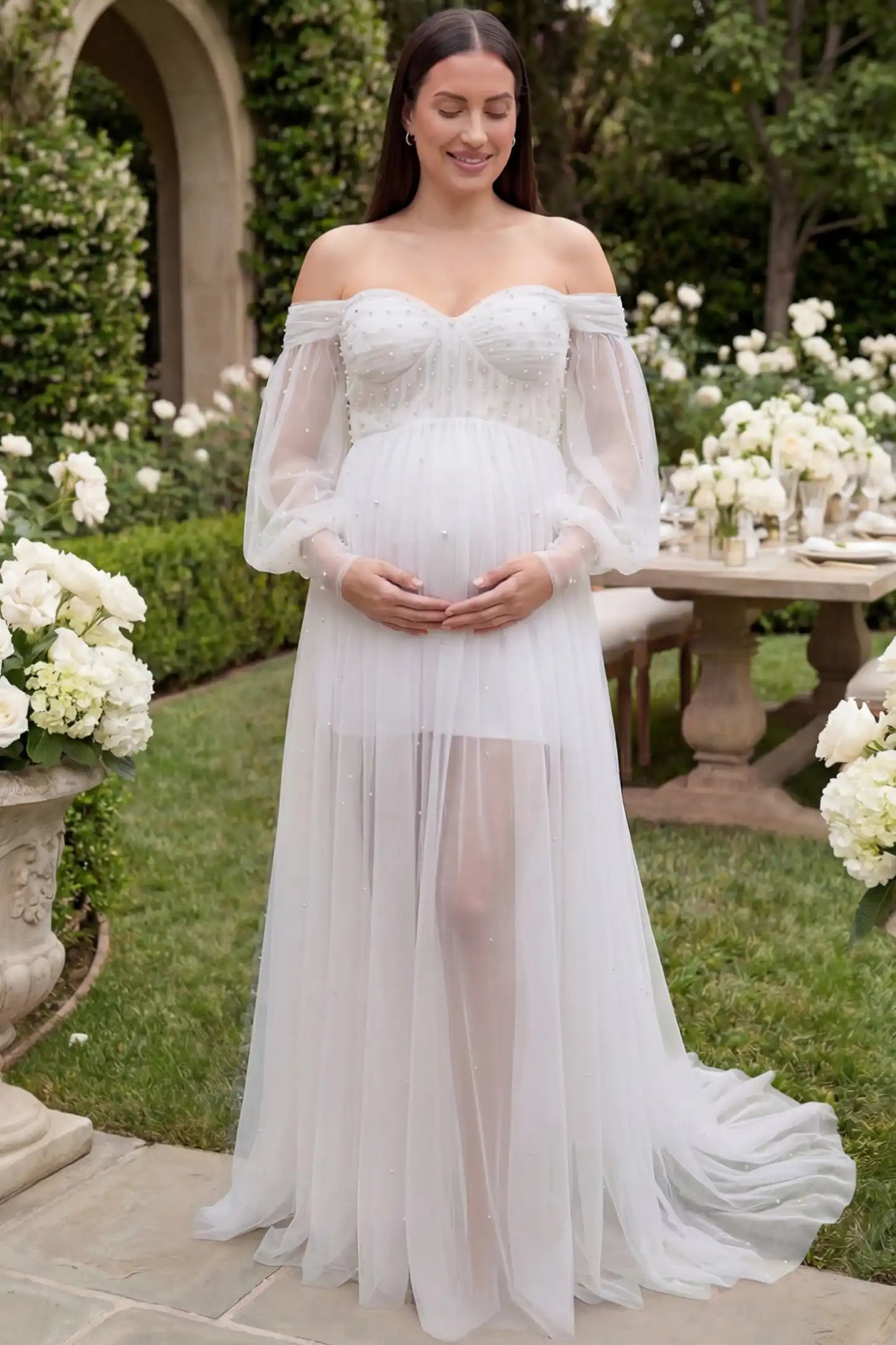 Off-Shoulder Empire Waist Maternity Gown Off-Shoulder Empire Waist Maternity Gown in white featuring a sweetheart neckline and flowy A-line silhouette on a plus size pregnant model, front view.