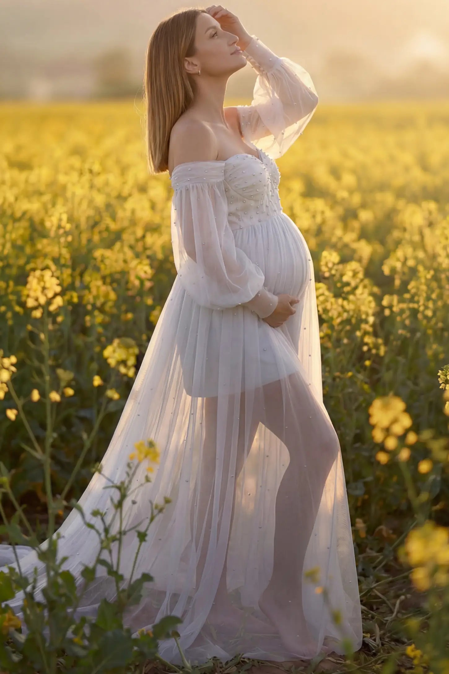 Off-Shoulder Empire Waist Maternity Gown Off-Shoulder Empire Waist Maternity Gown in white featuring a sweetheart neckline and flowy A-line silhouette on a pregnant model, side view.