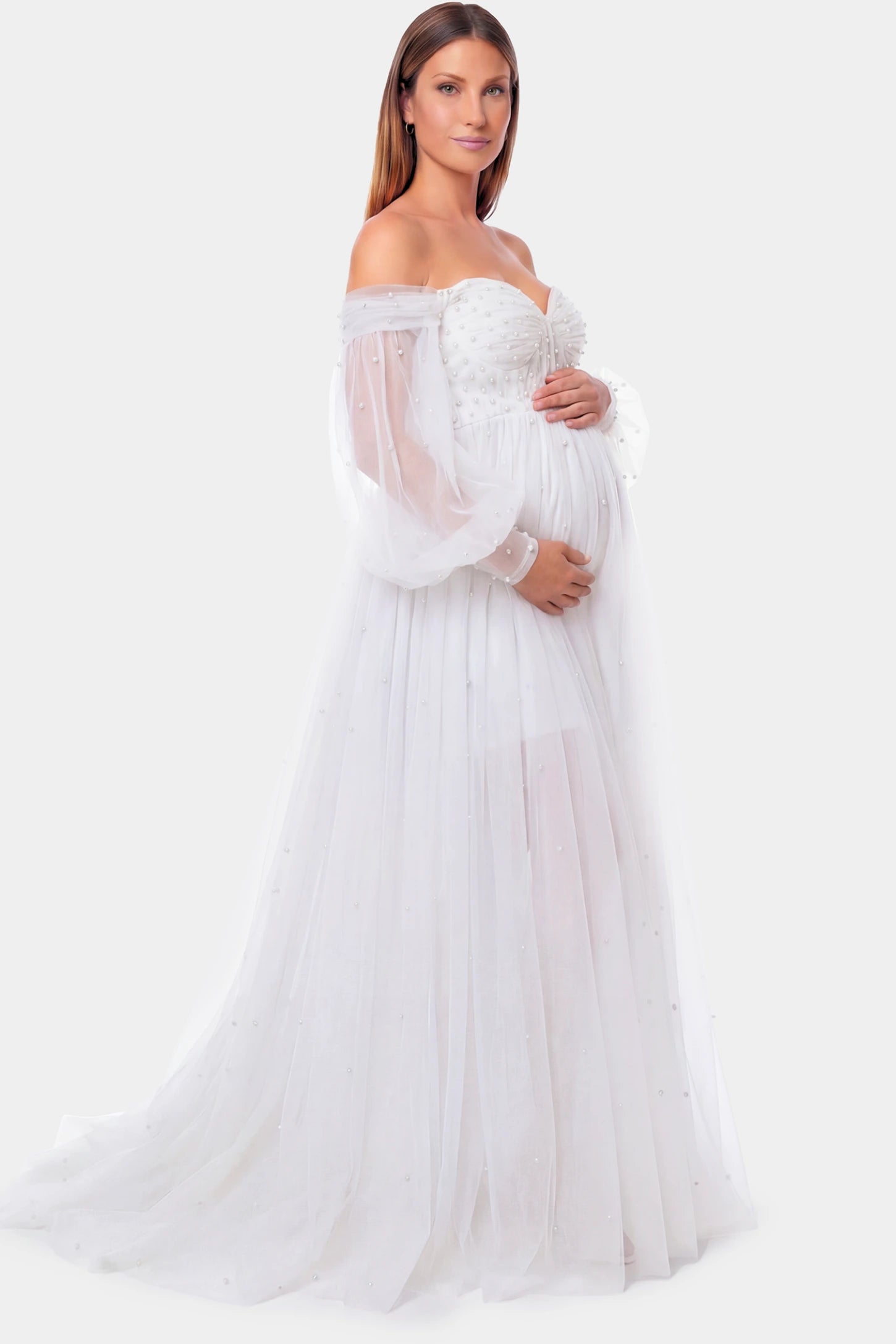 Off-Shoulder Empire Waist Maternity Gown Off-Shoulder Empire Waist Maternity Gown in white featuring a sweetheart neckline and flowy A-line silhouette on a pregnant model.