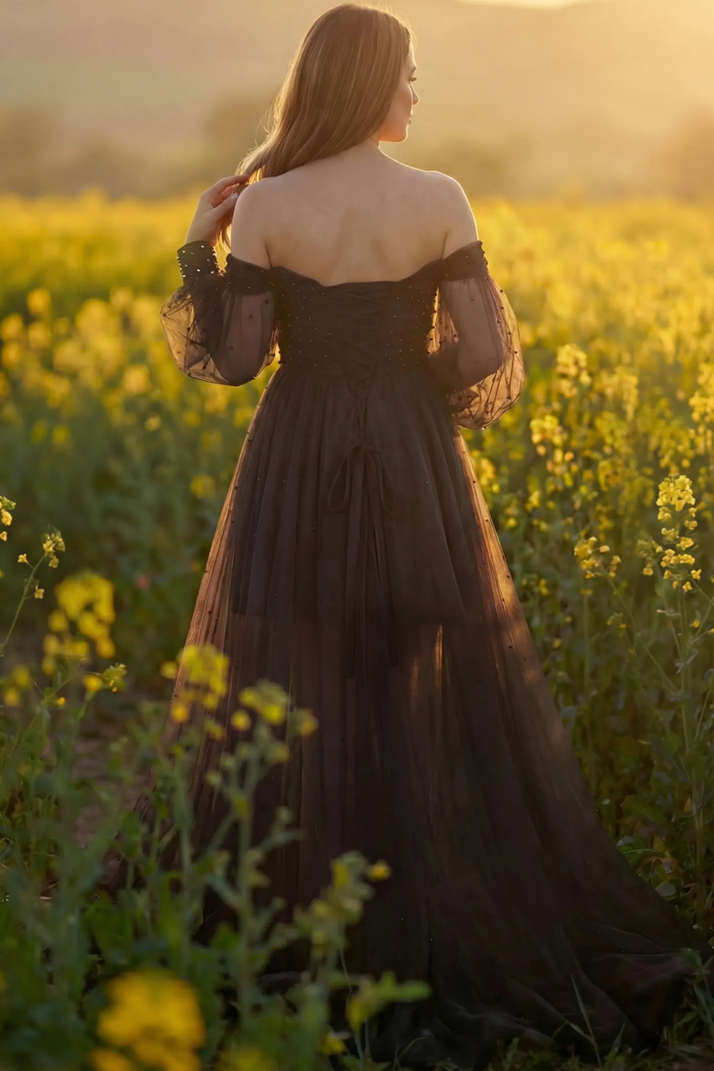 Off-Shoulder Empire Waist Maternity Gown Off-Shoulder Empire Waist Maternity Gown in black featuring a sweetheart neckline and flowy A-line silhouette on a pregnant model, back view.