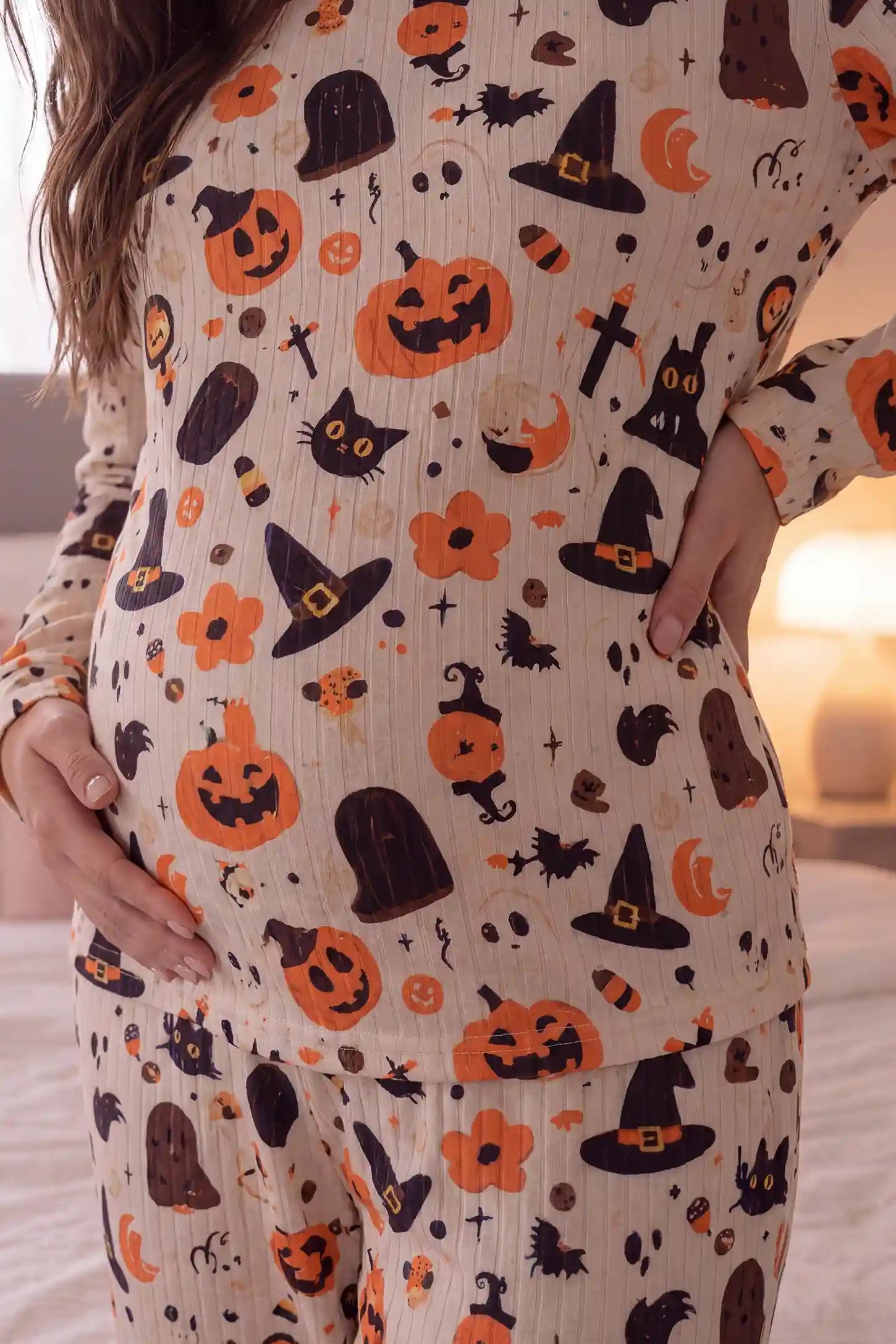 Pumpkin & Ghost Print Soft Knit Maternity Sleep Set Pumpkin & Ghost Print Soft Knit Maternity Sleep Set in Whimsical Halloween featuring accommodating belly stretch design, comfortable fit, and festive Halloween pattern on a pregnant model, belly close-up view.