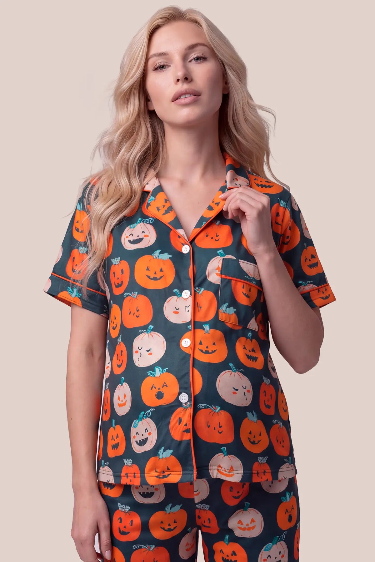 Pumpkin Spice Maternity PJ Set Pumpkin Spice Maternity PJ Set in Pumpkin featuring a classic notch lapel collar, easy button-front design, chest pocket, and charming pumpkin pattern on a model, upper body front view.