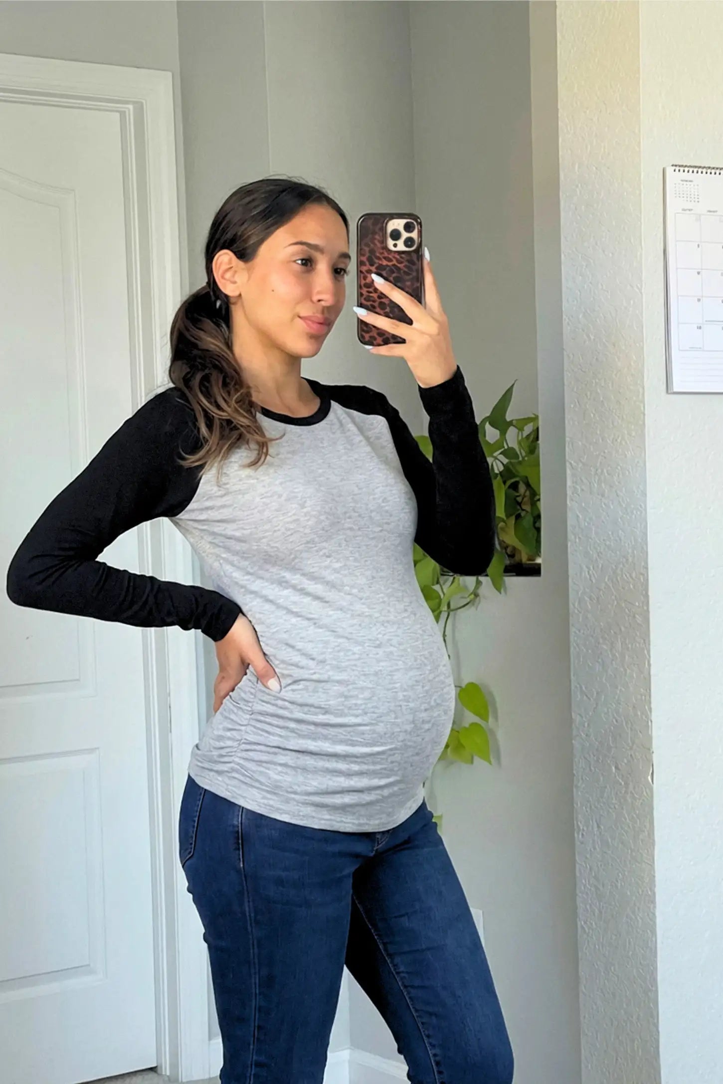 Ruched Raglan Sleeve Maternity Top Ruched Raglan Sleeve Maternity Top in black featuring a round neckline and gentle ruching on a pregnant model.