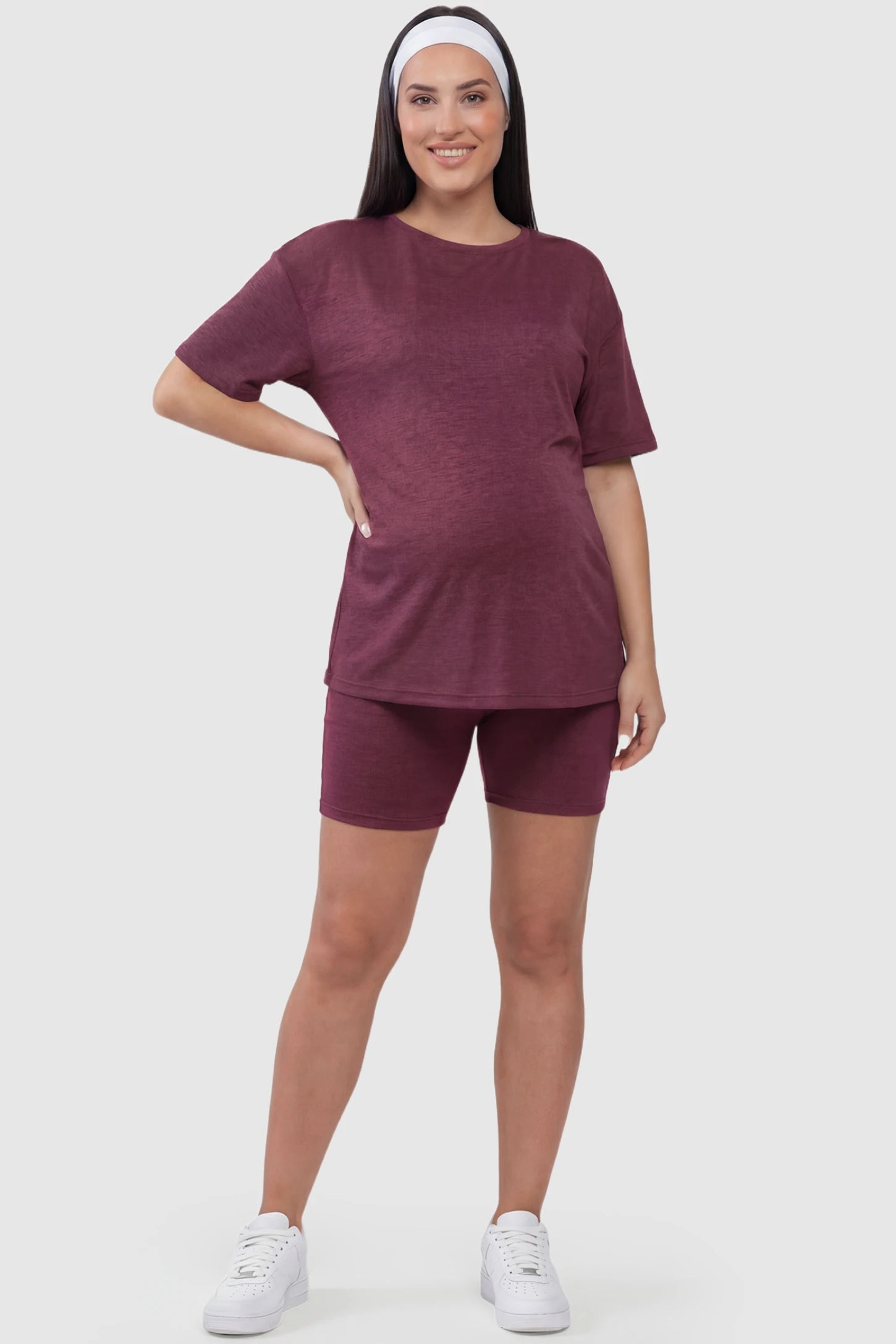 Stretch Oversized Tee & Biker Short Maternity Lounge Set Stretch Oversized Tee & Biker Short Maternity Lounge Set in burgundy featuring relaxed-fit T-shirt and mid-thigh fitted biker shorts on plus size pregnant model.