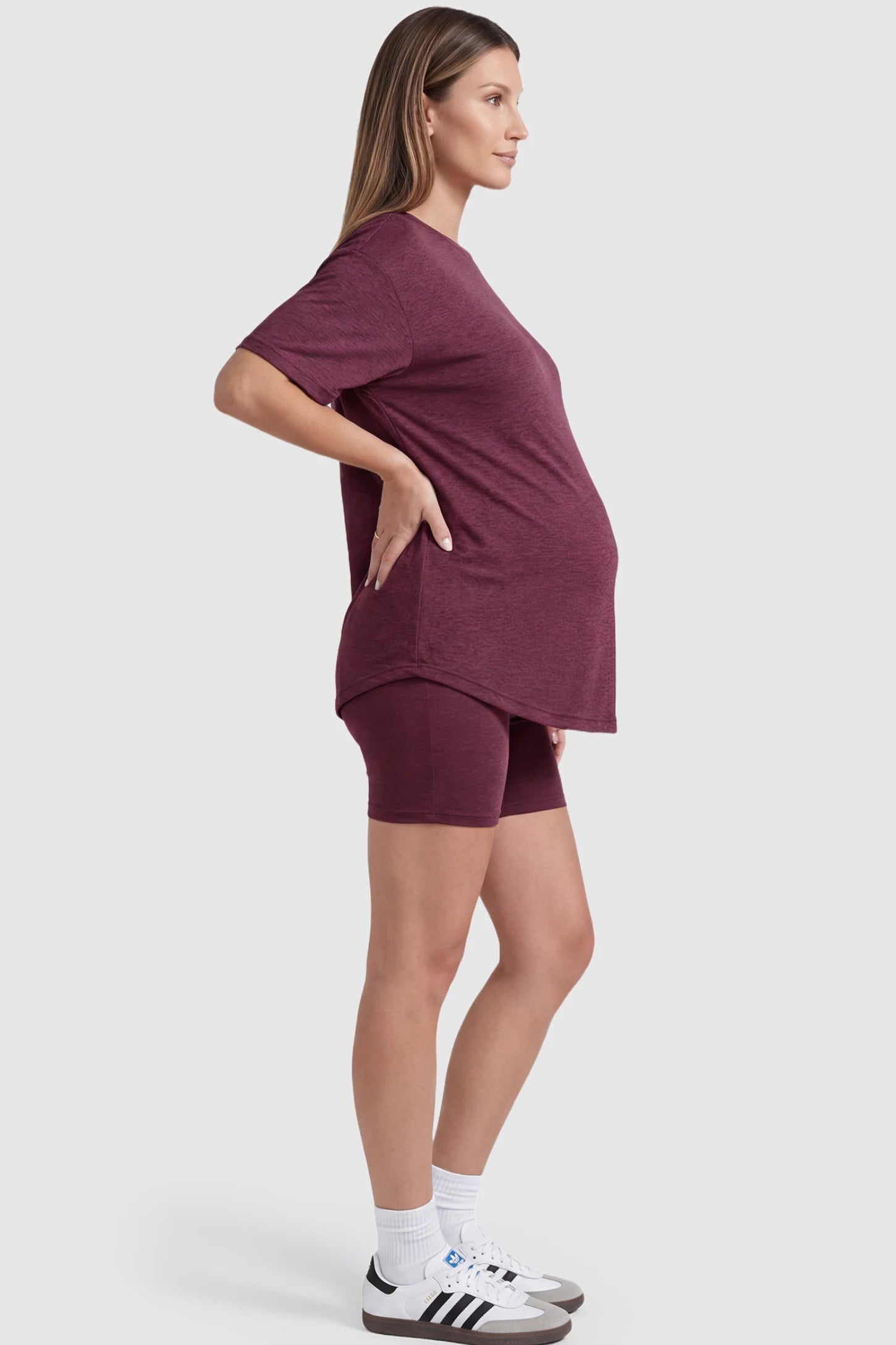 Stretch Oversized Tee & Biker Short Maternity Lounge Set Stretch Oversized Tee & Biker Short Maternity Lounge Set in burgundy featuring relaxed-fit T-shirt and mid-thigh fitted biker shorts on pregnant model.