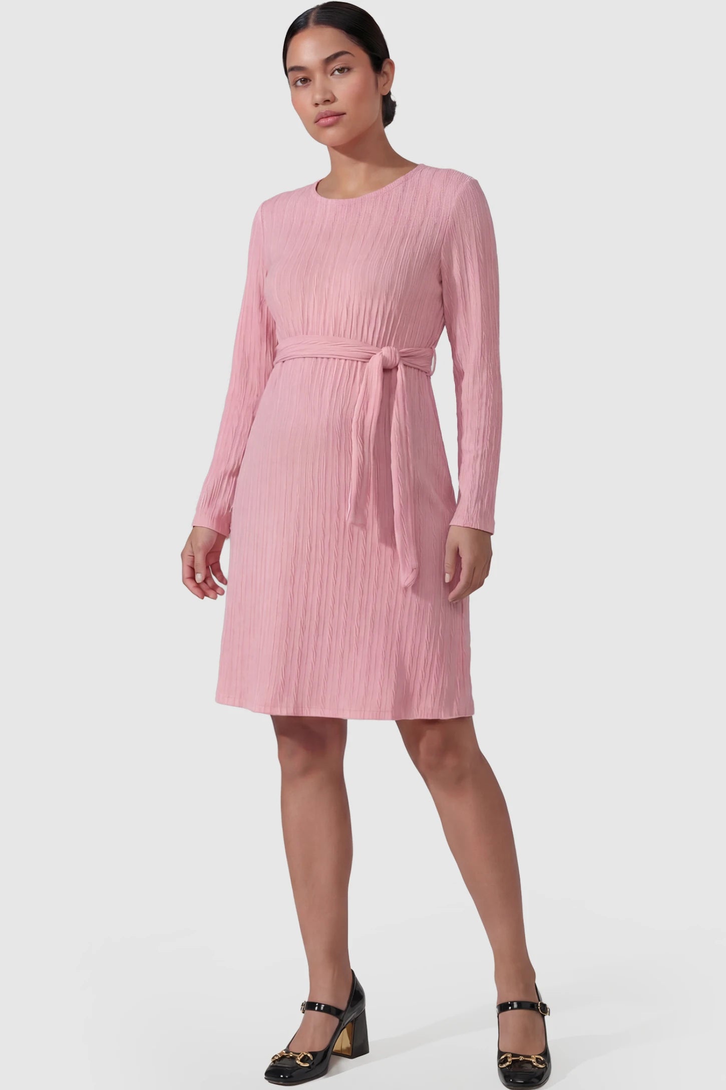 Ribbed Knit Long Sleeve Maternity Short Dress Ribbed Knit Long Sleeve Maternity Short Dress in pink featuring a ribbed texture and adjustable tie waist on a non pregnant model.