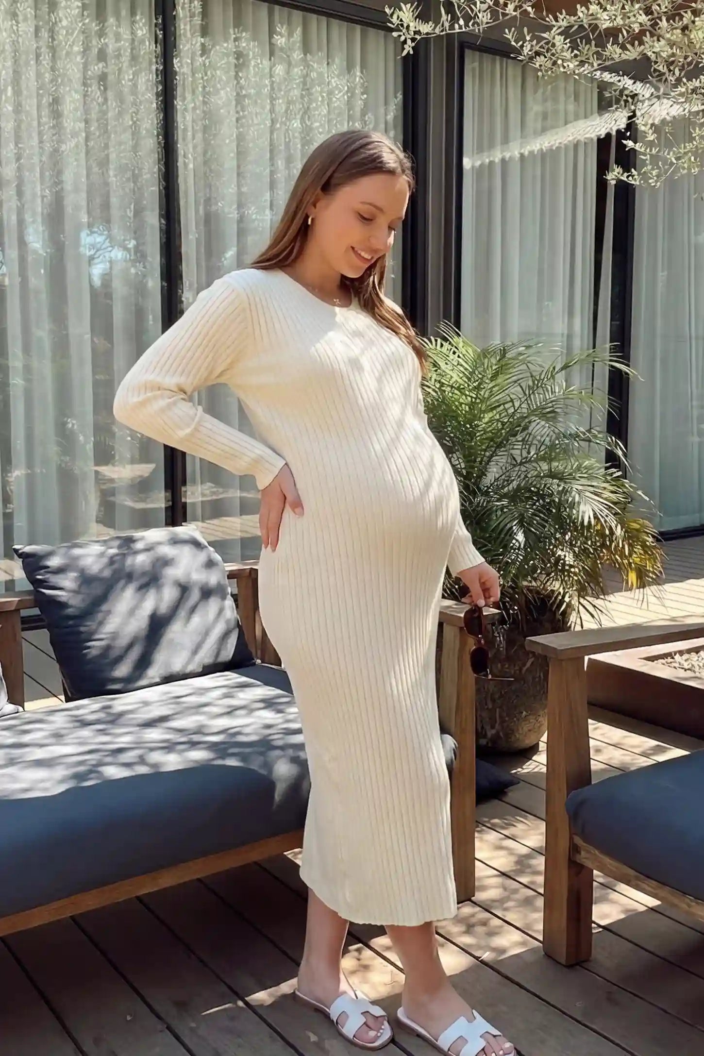 Ribbed Knit Long Sleeve Maternity Midi Dress Ribbed knit long sleeve maternity midi dress in apricot with smooth stretch ribbed knit fabric, side view on pregnant model