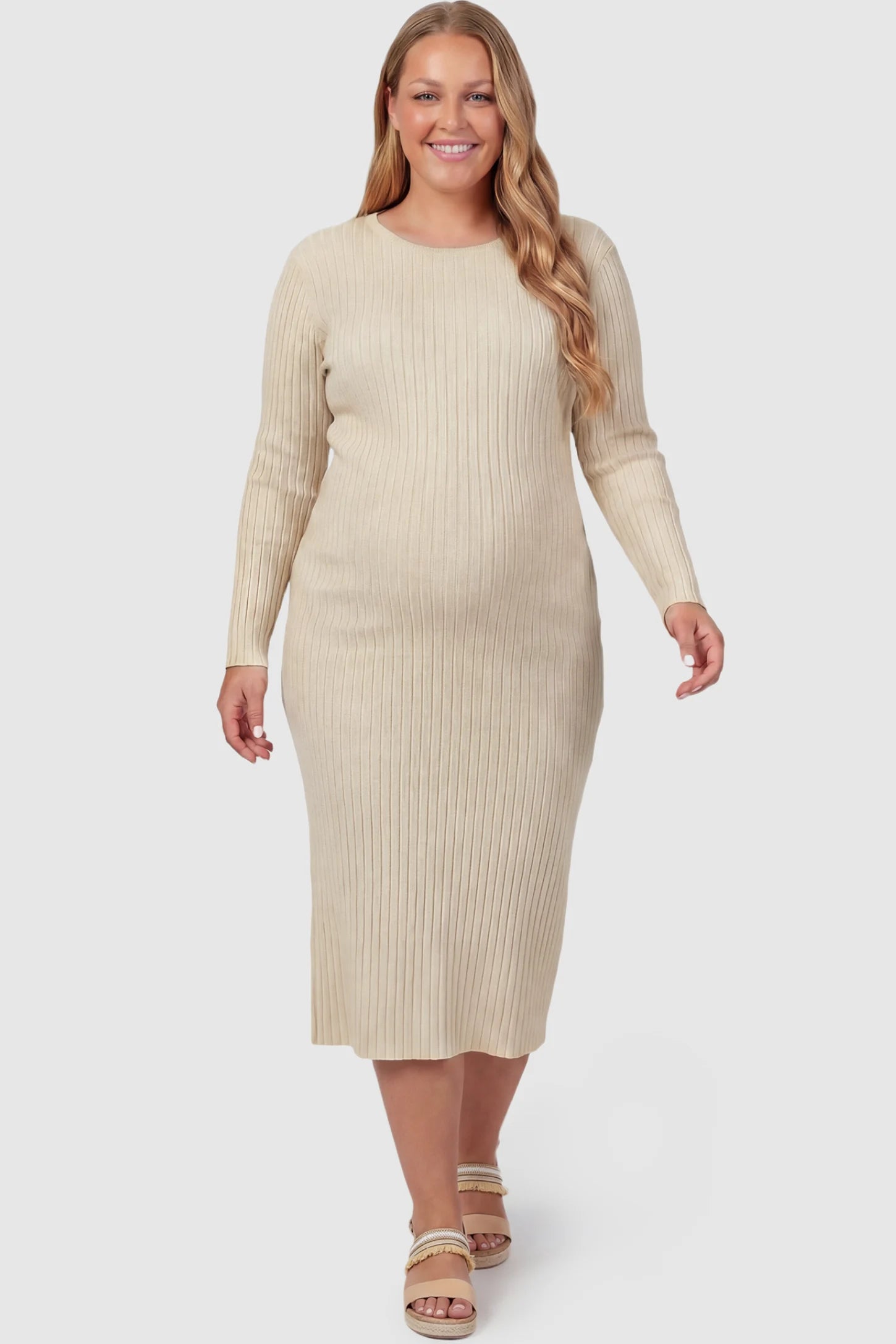 Ribbed Knit Long Sleeve Maternity Midi Dress Ribbed knit long sleeve maternity midi dress in apricot with smooth stretch ribbed knit fabric, front view on plus-size model