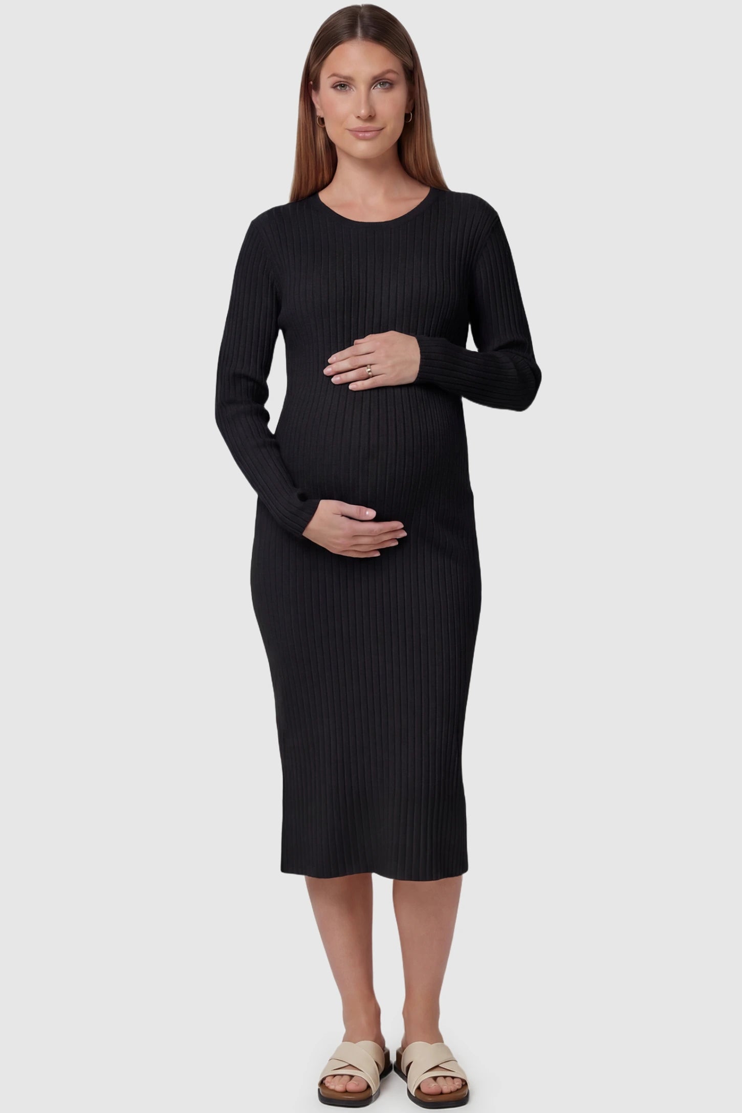 Ribbed knit long sleeve maternity midi dress in black with smooth stretch ribbed knit fabric, front view on pregnant model