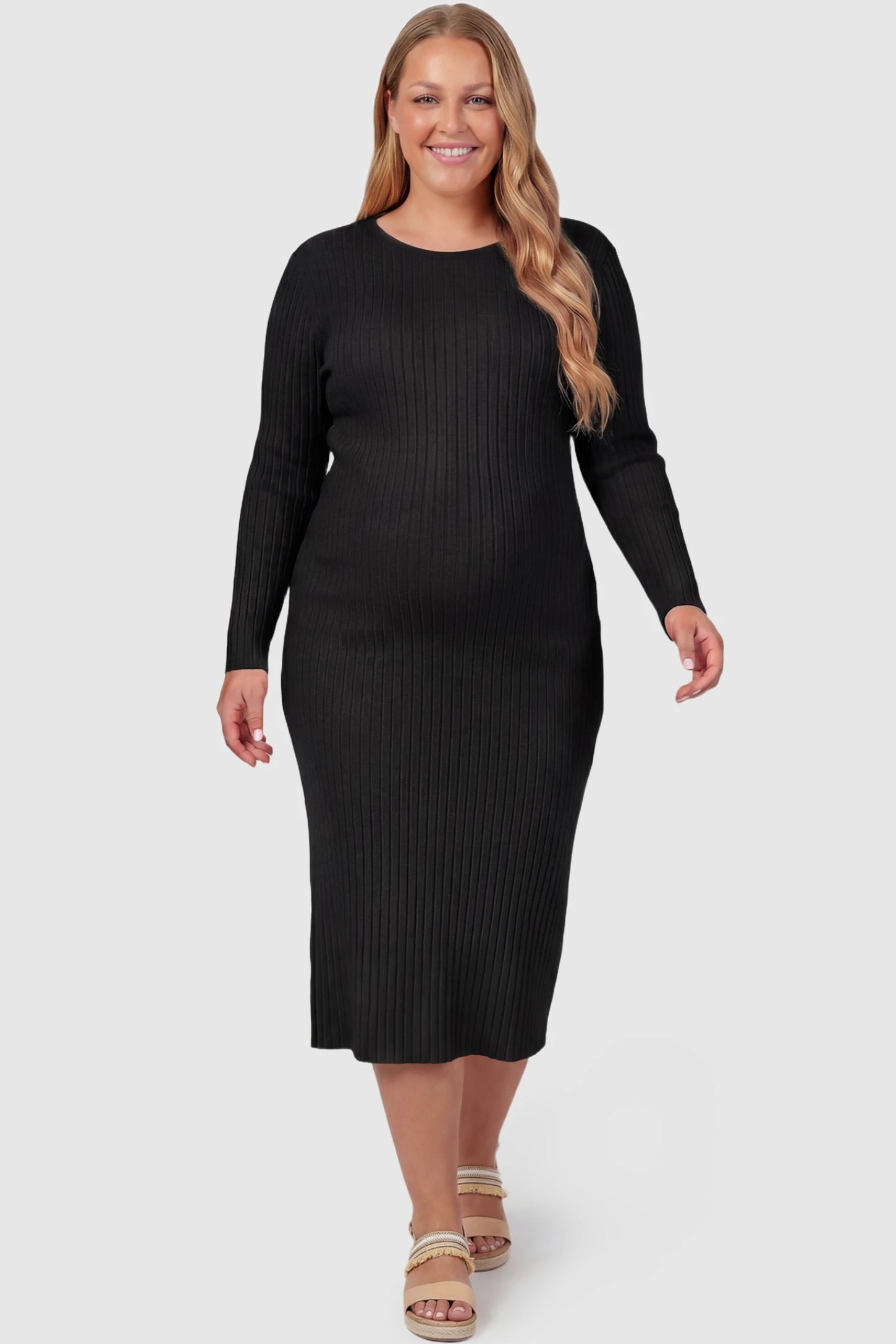 Ribbed Knit Long Sleeve Maternity Midi Dress Ribbed knit long sleeve maternity midi dress in black with smooth stretch ribbed knit fabric, front view on plus-size model