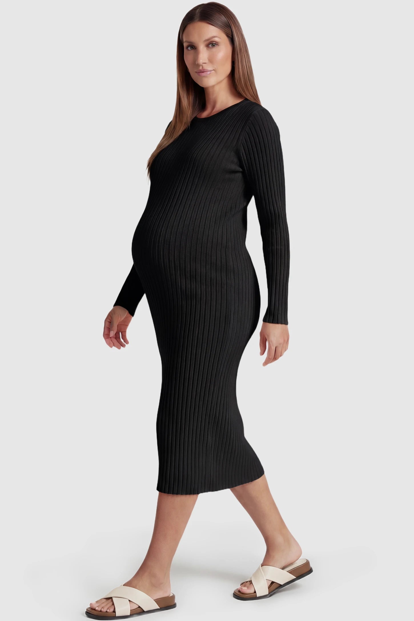 Ribbed Knit Long Sleeve Maternity Midi Dress Ribbed knit long sleeve maternity midi dress in black with smooth stretch ribbed knit fabric, side view on pregnant model