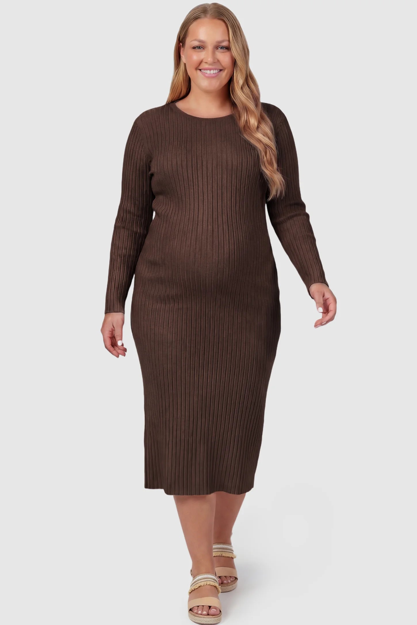 Ribbed Knit Long Sleeve Maternity Midi Dress Ribbed knit long sleeve maternity midi dress in brown with smooth stretch ribbed knit fabric, front view on plus-size model