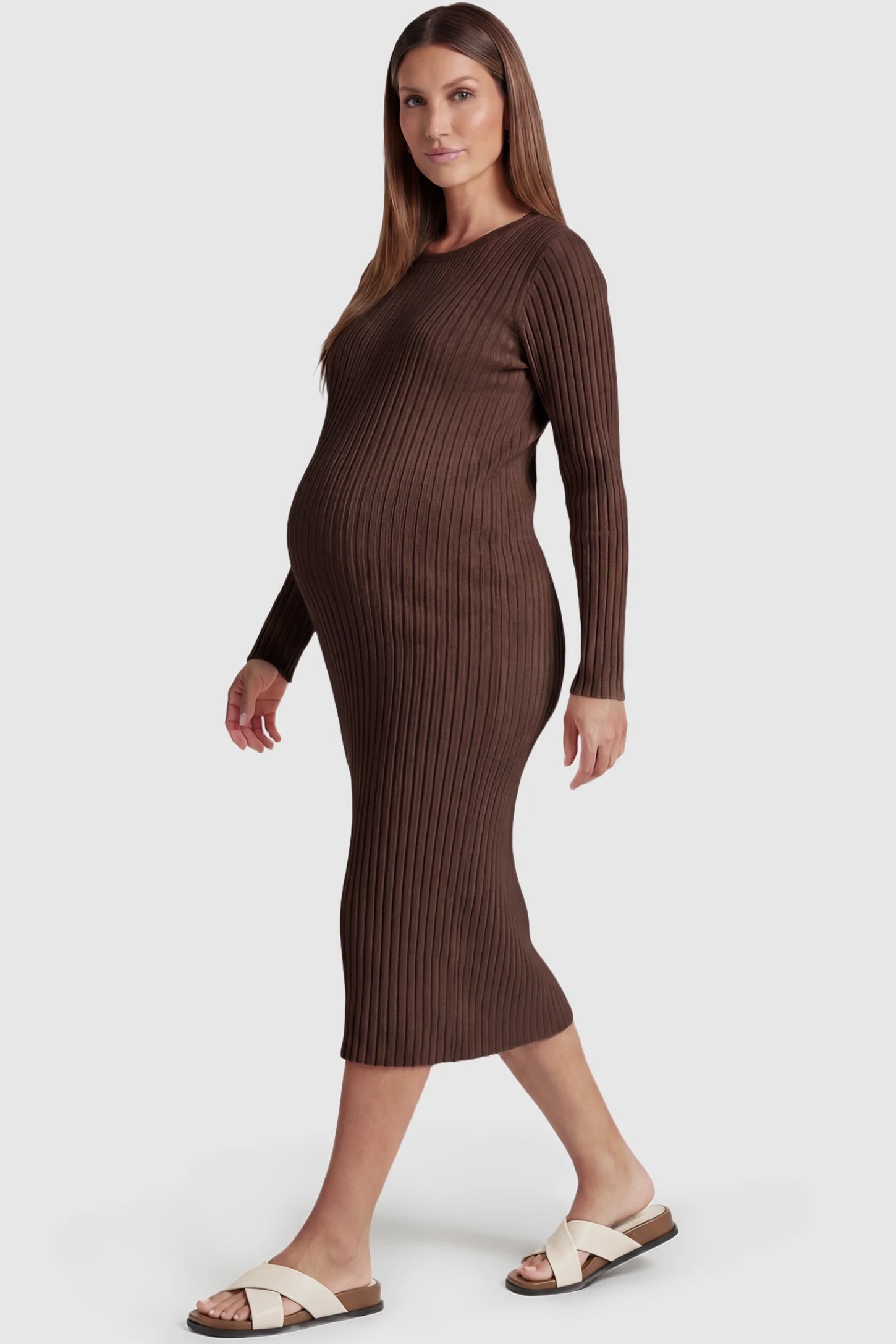Ribbed Knit Long Sleeve Maternity Midi Dress Ribbed knit long sleeve maternity midi dress in brown with smooth stretch ribbed knit fabric, side view on pregnant model