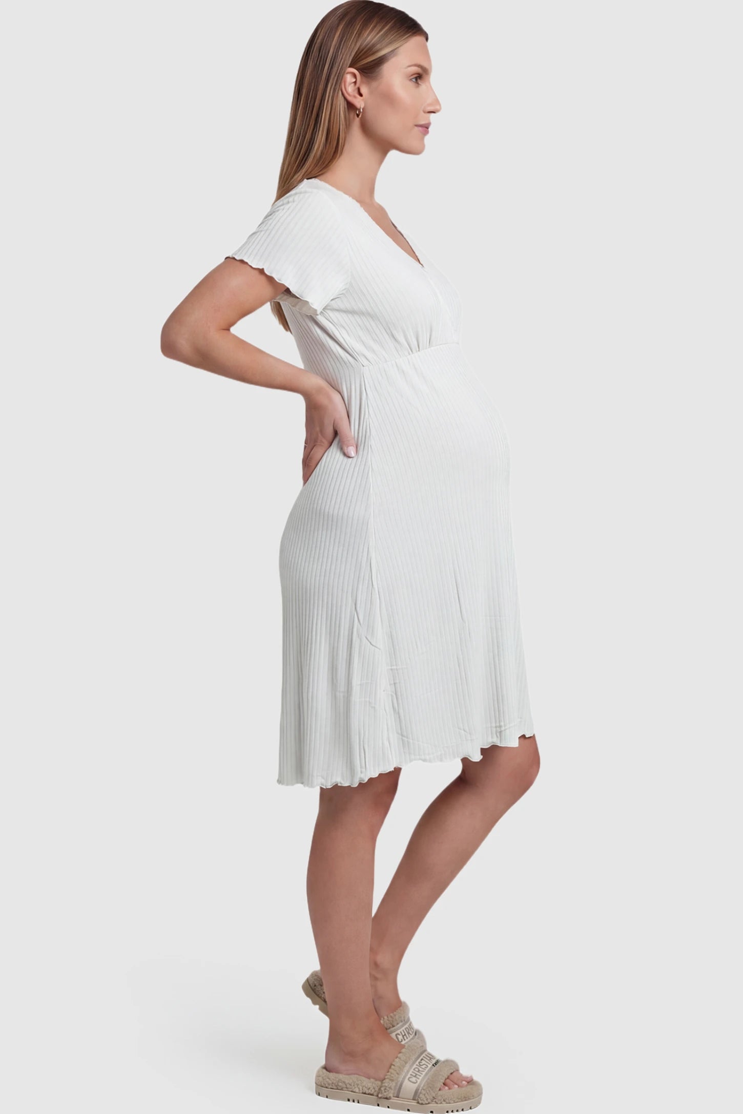 Wrap Style Ribbed Maternity & Nursing Sleepwear Wrap Style Ribbed Maternity & Nursing Midi Lounge Dress in white featuring wrap-style front for easy nursing access on pregnant model showing side.