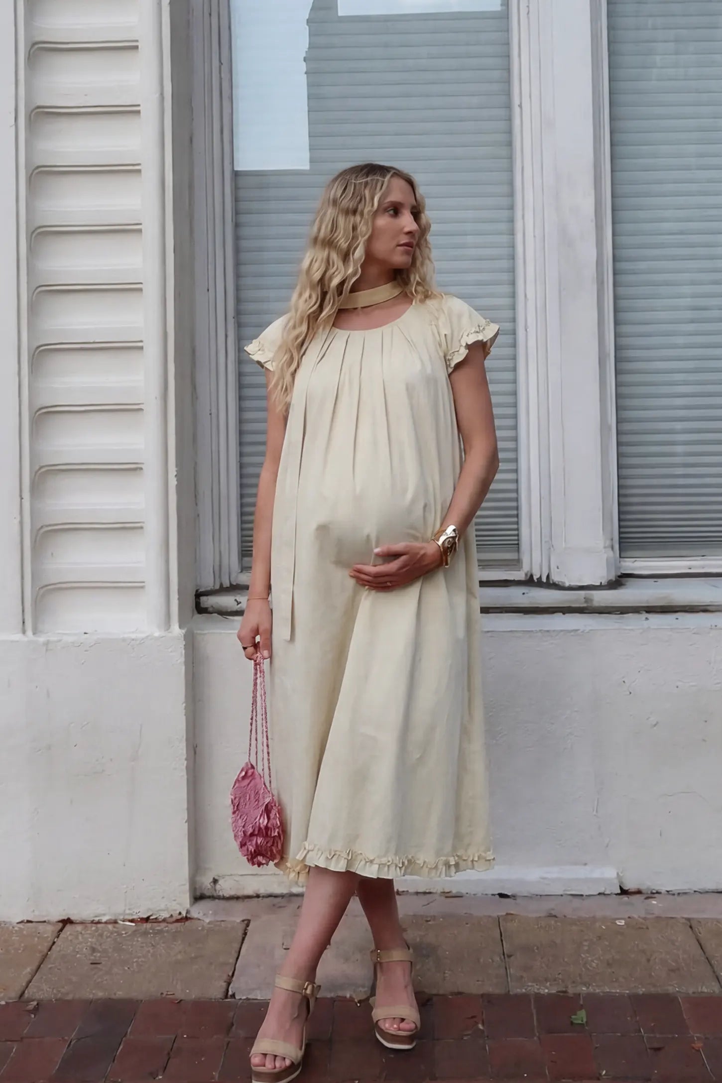 Round Neck Short Sleeve Maternity Midi Dress with Pockets Round neck short sleeve maternity midi dress with pockets in beige with round neckline and tie neck detail, front view on pregnant model