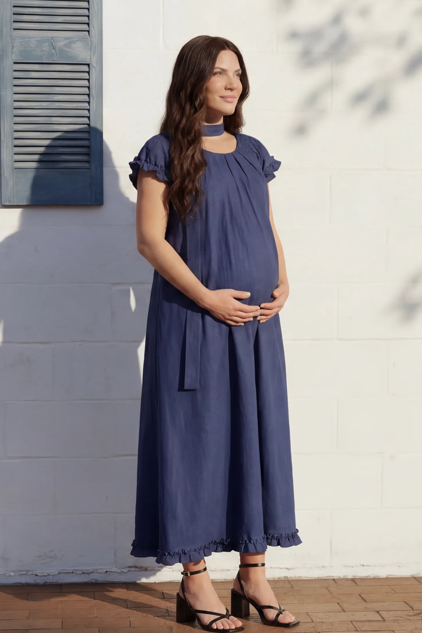 Round Neck Short Sleeve Maternity Midi Dress with Pockets Round neck short sleeve maternity midi dress with pockets in blue with round neckline and tie neck detail, front view on pregnant model