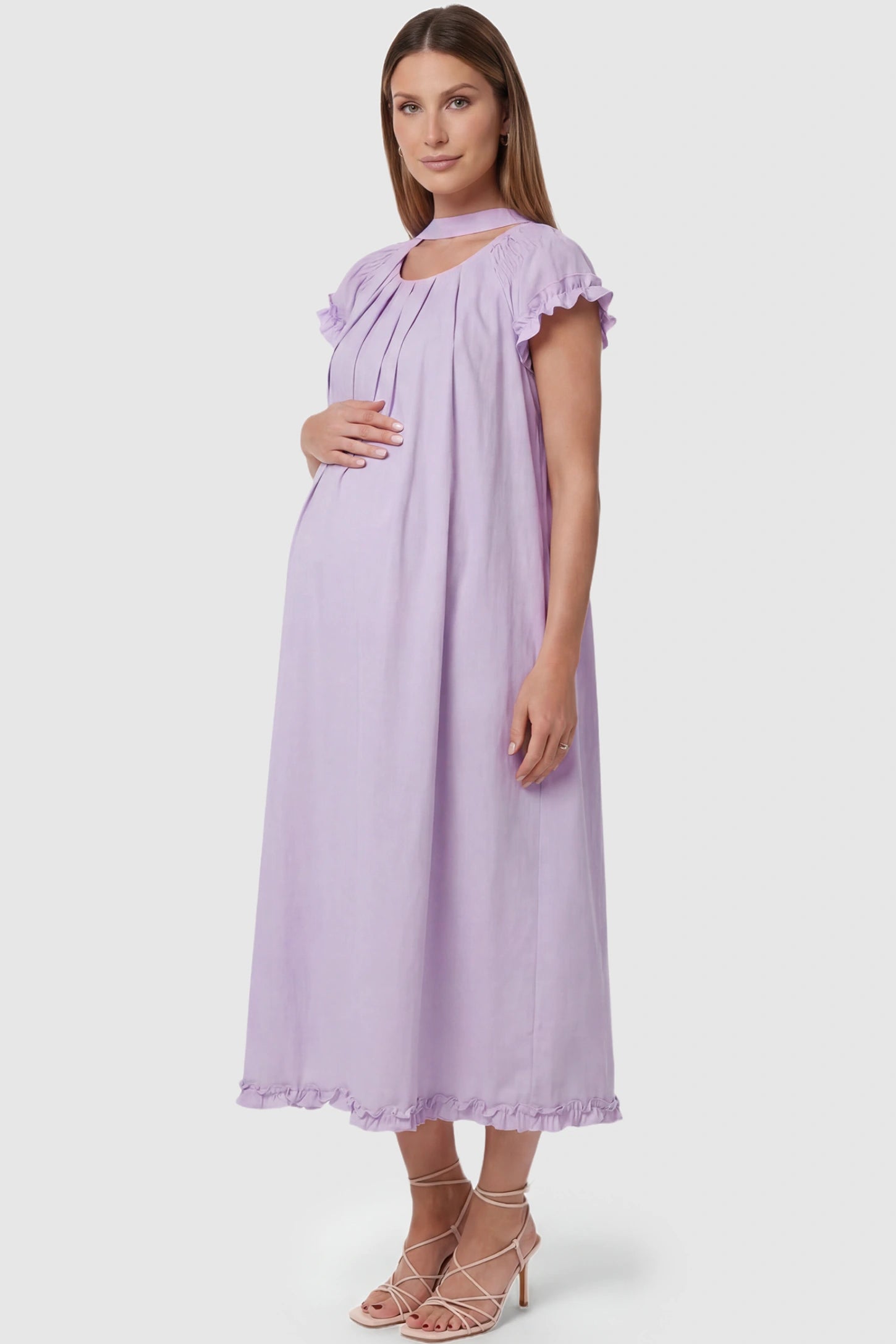 Round Neck Short Sleeve Maternity Midi Dress with Pockets Round neck short sleeve maternity midi dress with pockets in purple with shorts sleeve and tie neck detail, side view on pregnant model