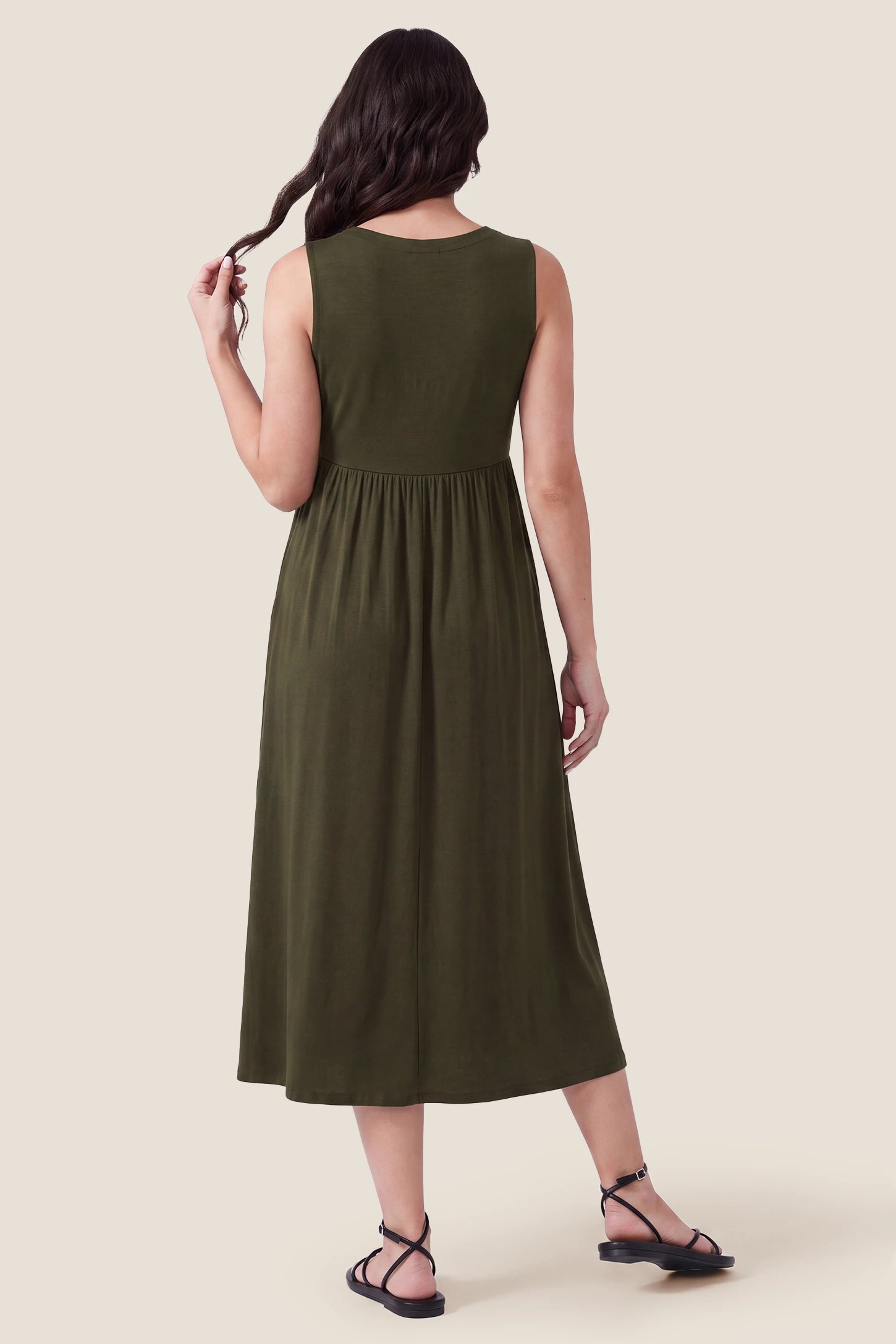 Drawstring Waist Sleeveless Full Skirt Maternity Skater Dress Drawstring Waist Sleeveless Maternity Skater Dress in Army Green featuring a high-back full skirt on a postpartum model.