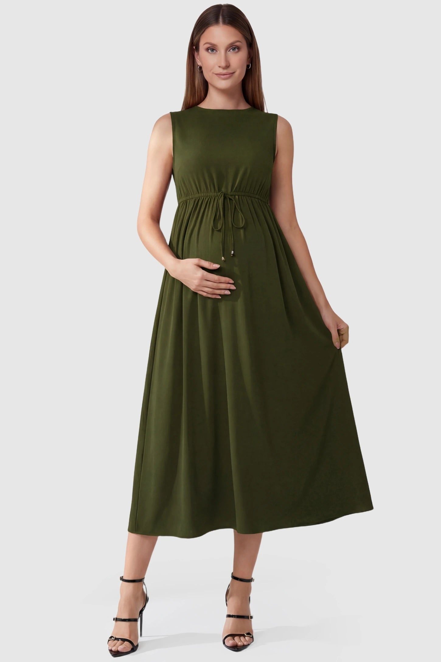 Drawstring Waist Sleeveless Full Skirt Maternity Skater Dress Drawstring Waist Sleeveless Maternity Skater Dress in Army Green featuring a flexible adjustable waist on a pregnant model.