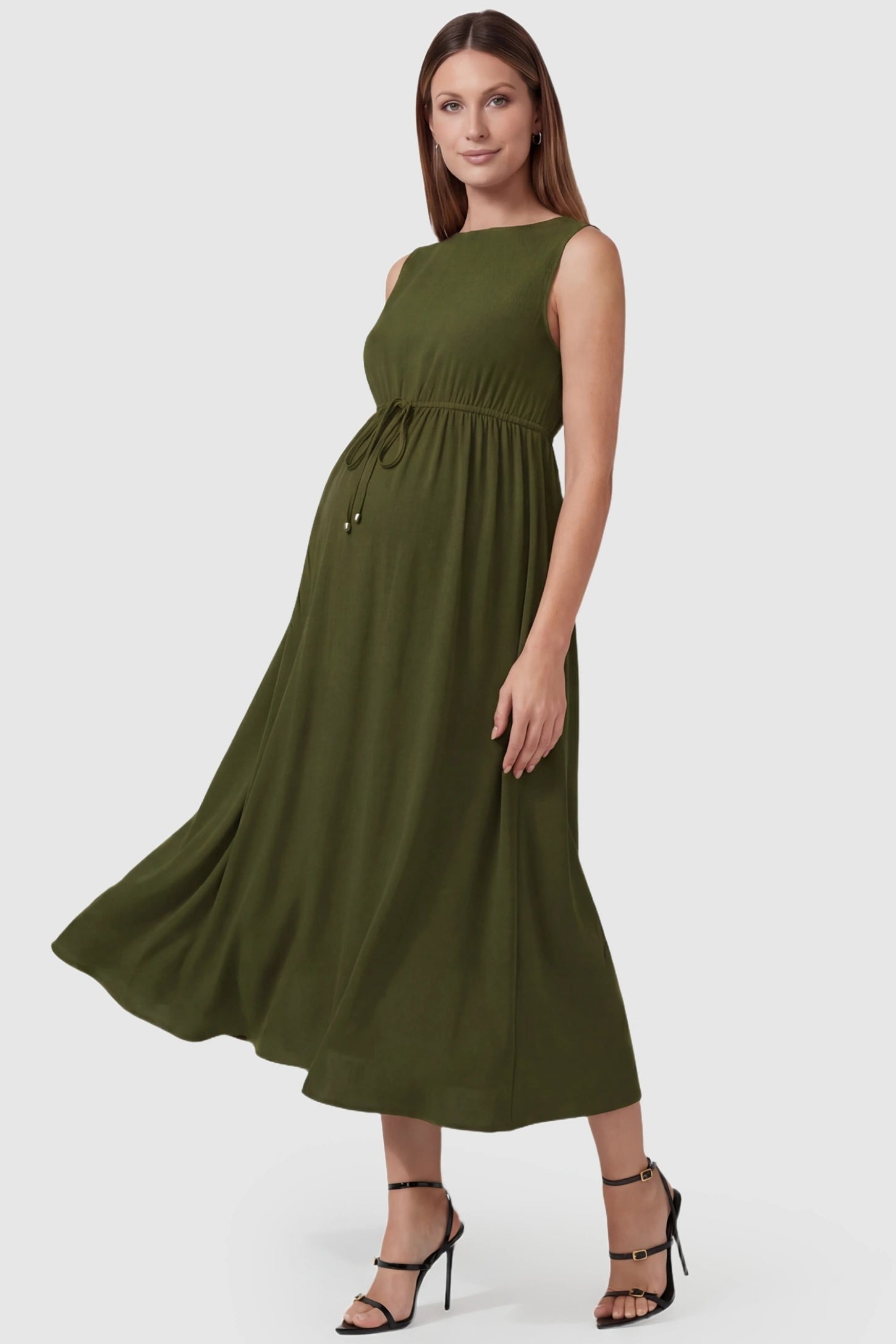 Drawstring Waist Sleeveless Full Skirt Maternity Skater Dress Drawstring Waist Sleeveless Maternity Skater Dress in Army Green featuring a side profile bump view on a pregnant model.