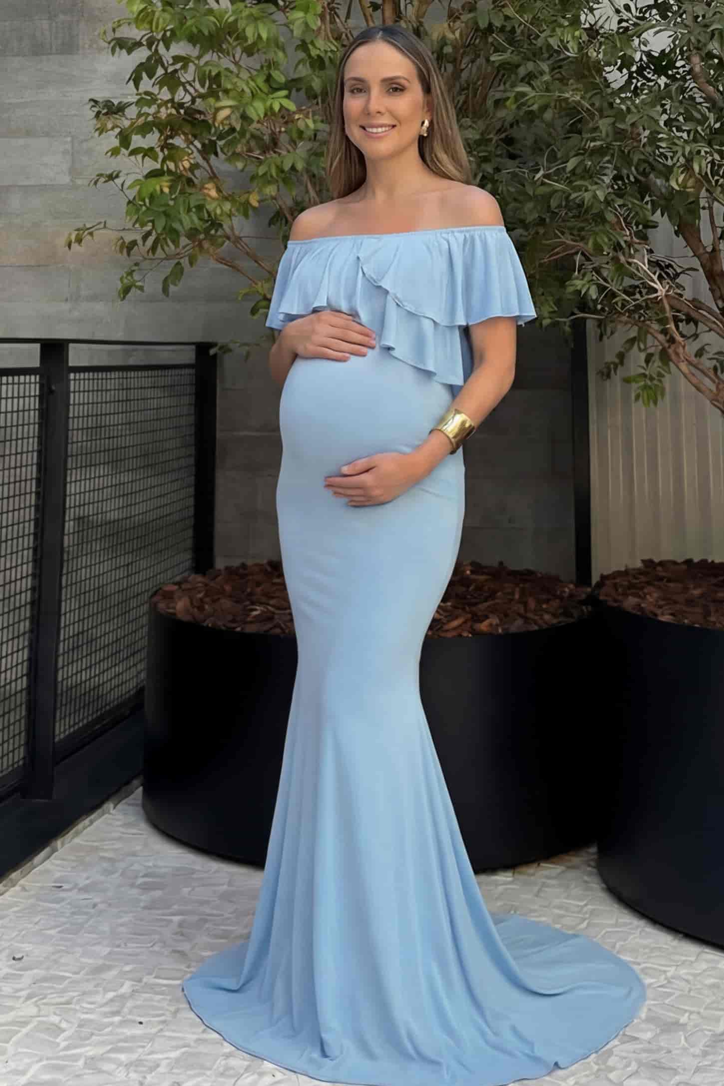 Off-Shoulder Mermaid Maternity Gown Off-Shoulder Mermaid Maternity Gown in light blue featuring ruffle overlay, flounce neckline, and sweep train on pregnant model.