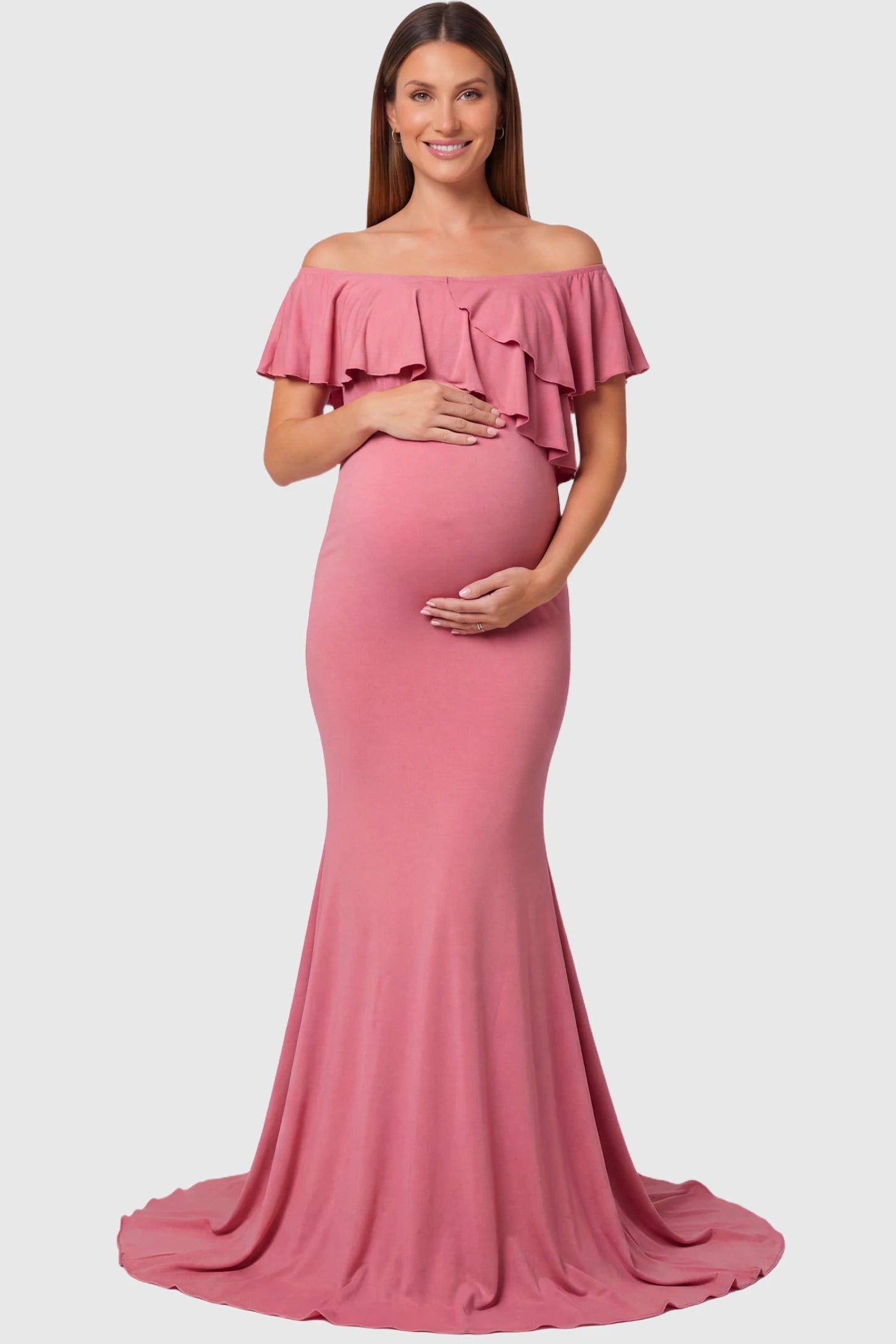 Off-Shoulder Mermaid Maternity Gown Off-Shoulder Mermaid Maternity Gown in pink featuring ruffle overlay, flounce neckline, and sweep train on pregnant model.