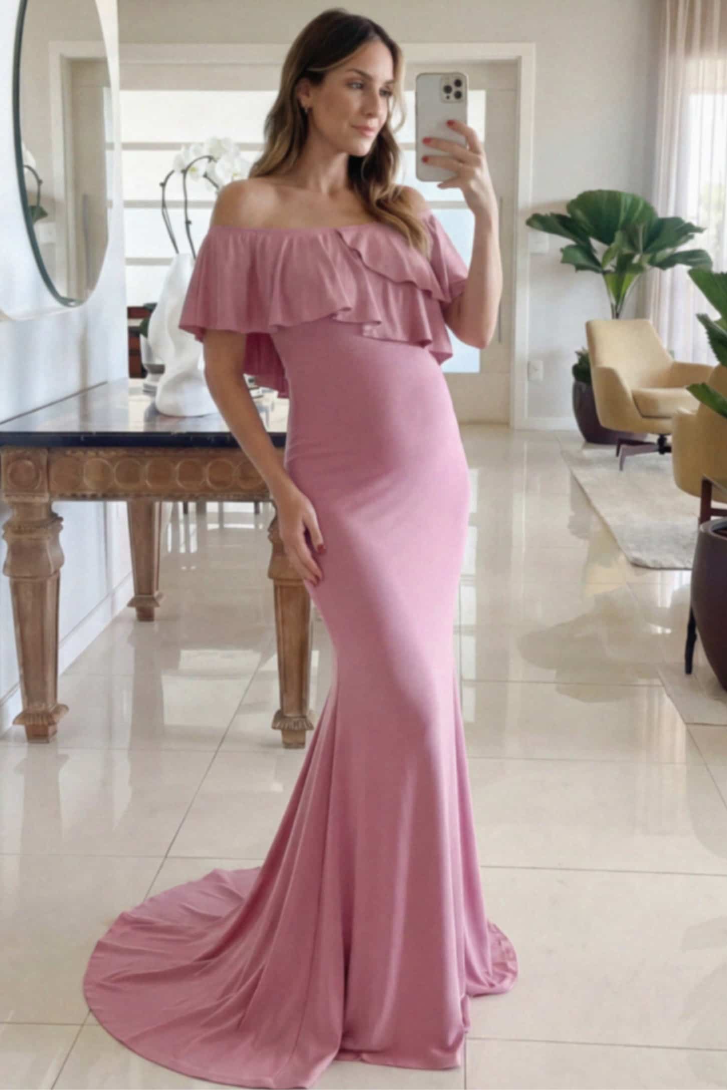 Off-Shoulder Mermaid Maternity Gown Off-Shoulder Mermaid Maternity Gown in pink featuring ruffle overlay, flounce neckline, and sweep train on pregnant model.