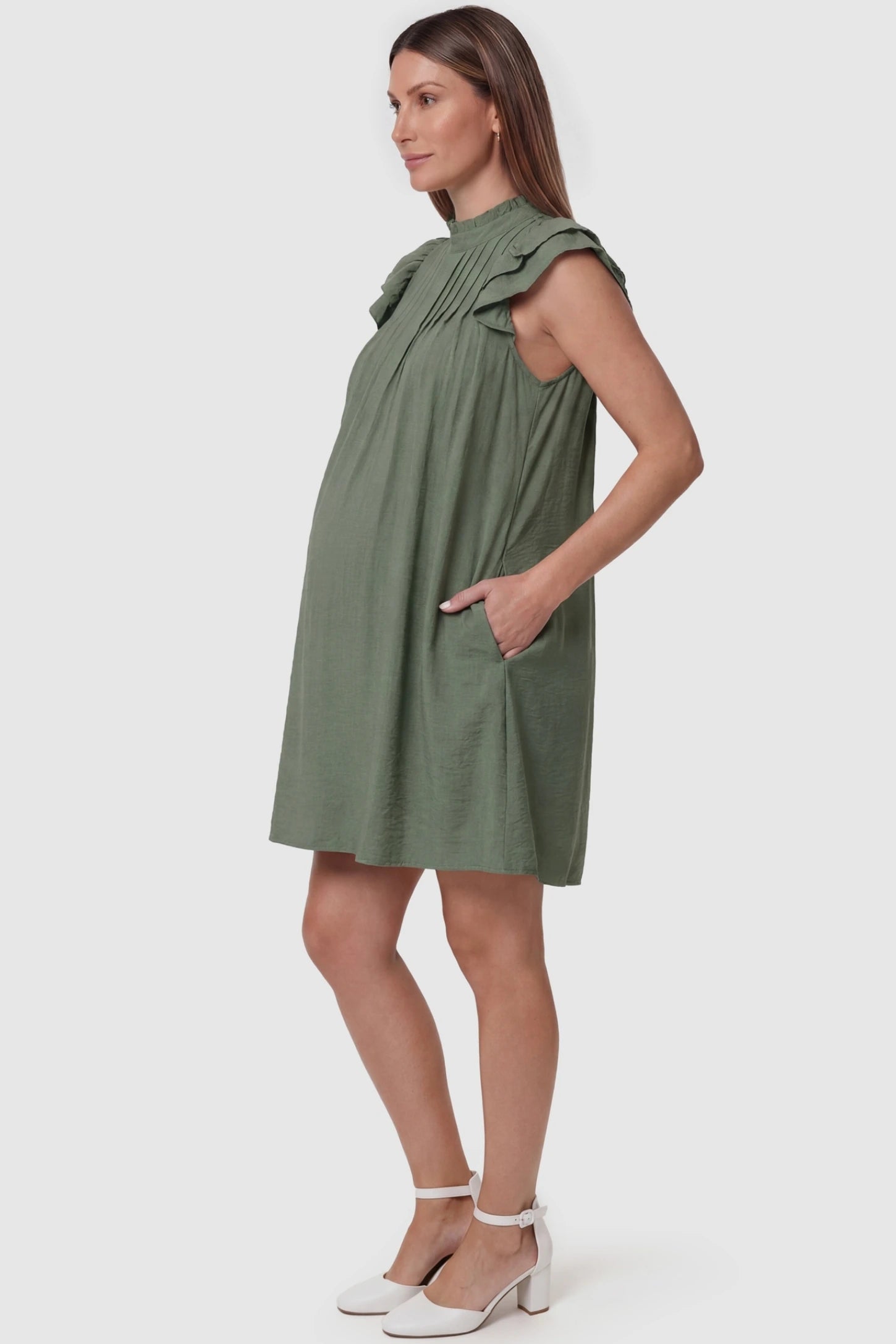 Ruffle Sleeve Pleated A-Line Maternity Mini Dress Ruffle Sleeve Pleated A-Line Maternity Mini Dress in Green featuring functional side pockets and pleat detailing on a pregnant model.