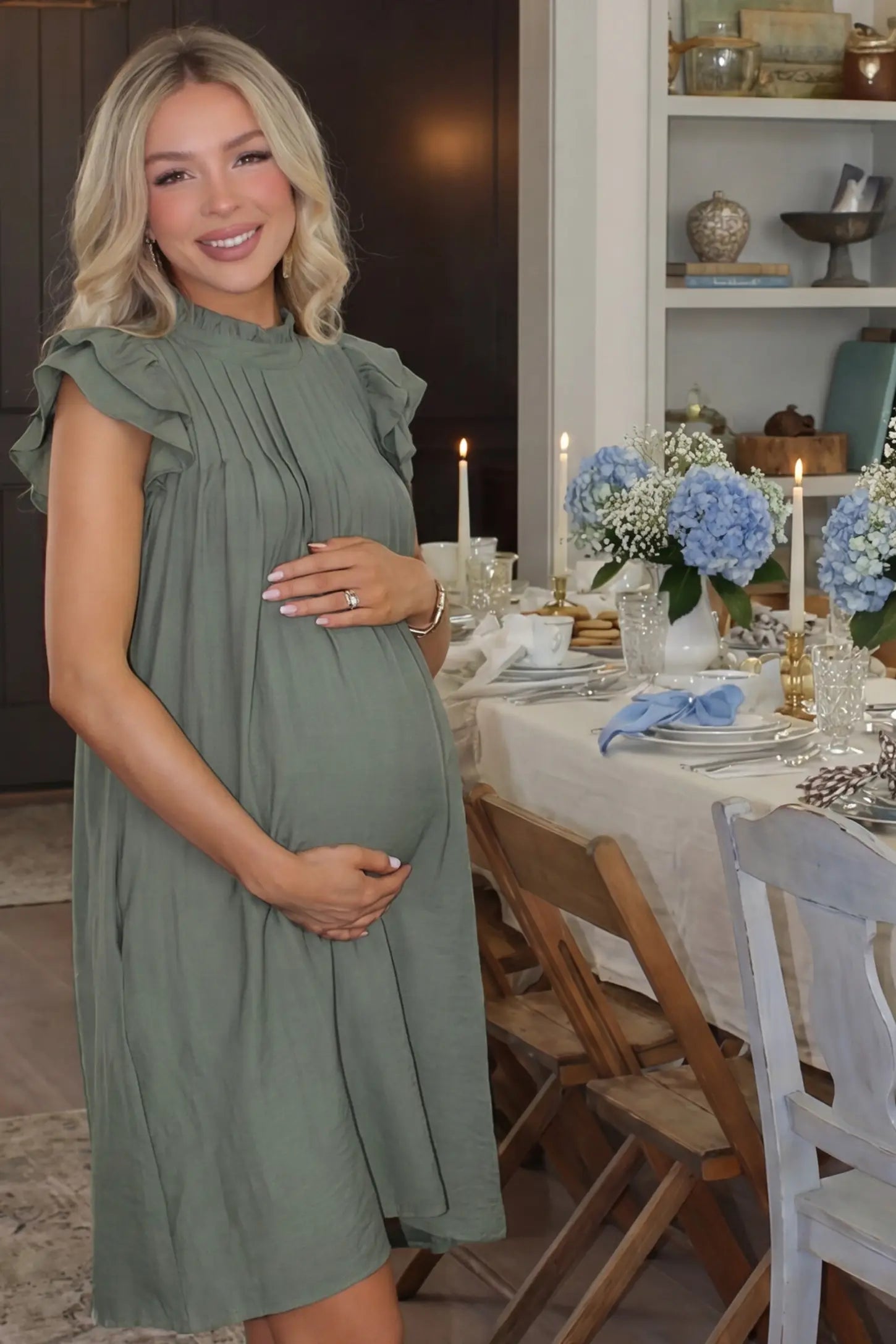 Ruffle Sleeve Pleated A-Line Maternity Mini Dress Ruffle Sleeve Pleated A-Line Maternity Mini Dress in Green featuring a ruffled neckline dress style on a pregnant model at a baby shower.