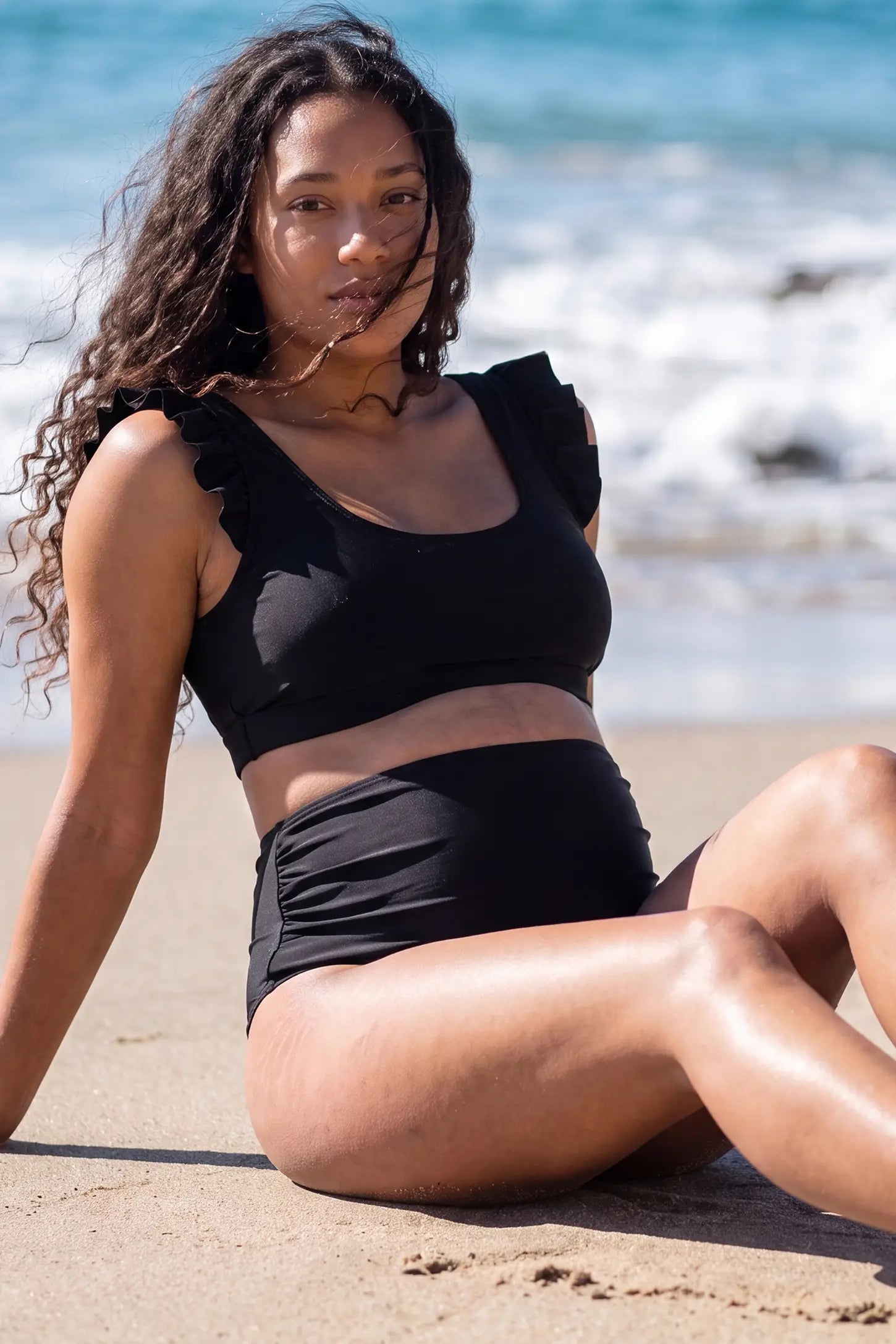 Ruffle Strap High Waisted Two-Piece Bikini Ruffle Strap High Waisted Two-Piece Bikini in Black featuring ruffle shoulder straps, a supportive bikini top, matching high-waisted bottoms, and a flattering maternity-friendly fit on a pregnant model, front view-2.