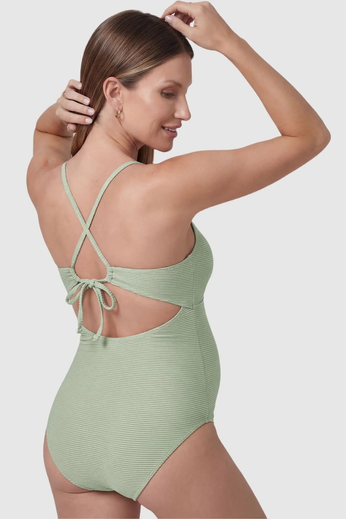 Ruffle Trim Halter Neck Maternity Swimsuit Ruffle Trim Halter Neck Maternity Swimsuit in Mint Green featuring a crisscross tie-back on a back-facing pregnant model.