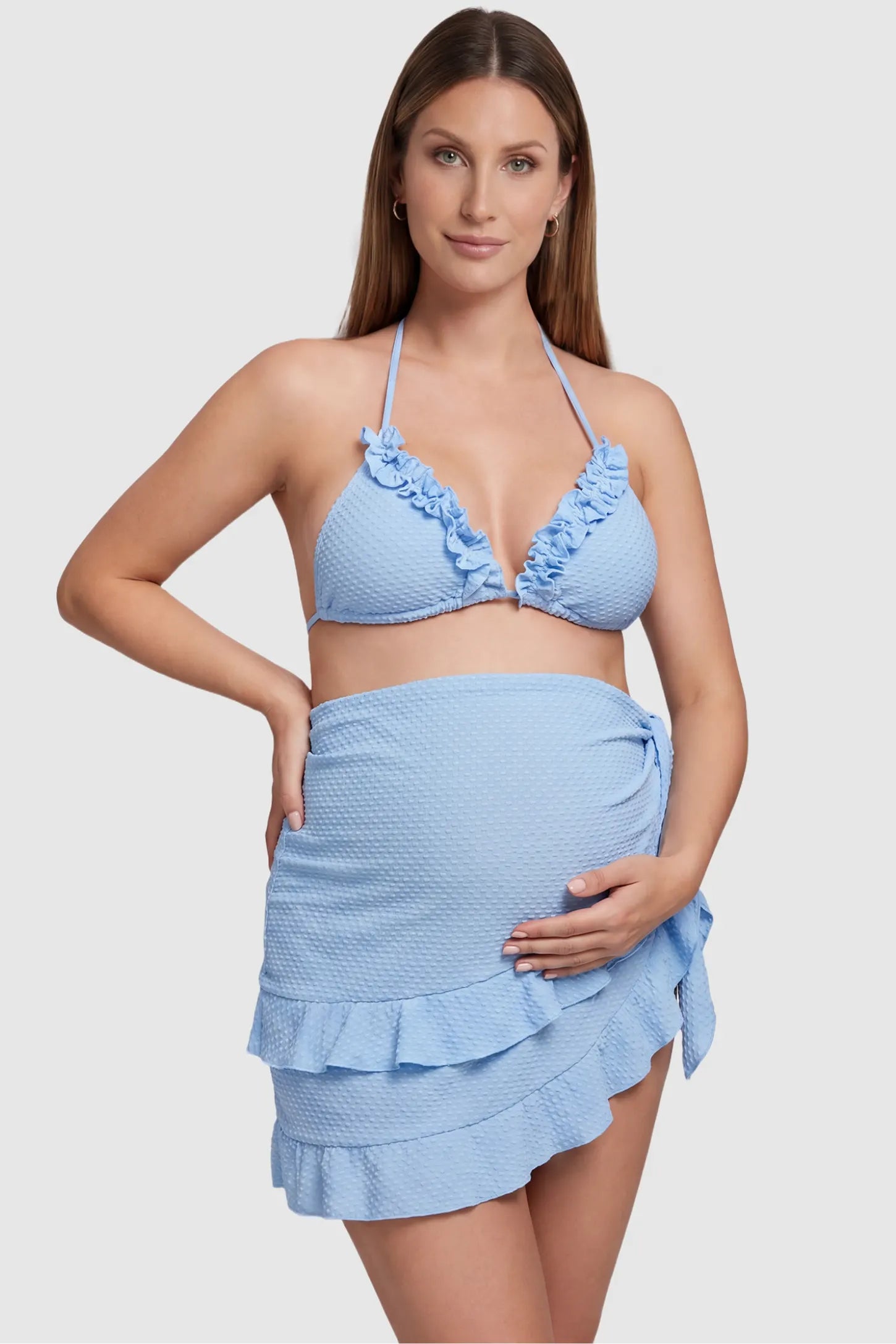Ruffled Trim Halter Maternity Bikini Set Ruffled trim halter maternity bikini set in blue with halter neckline and ruffle detail, front view on pregnant model