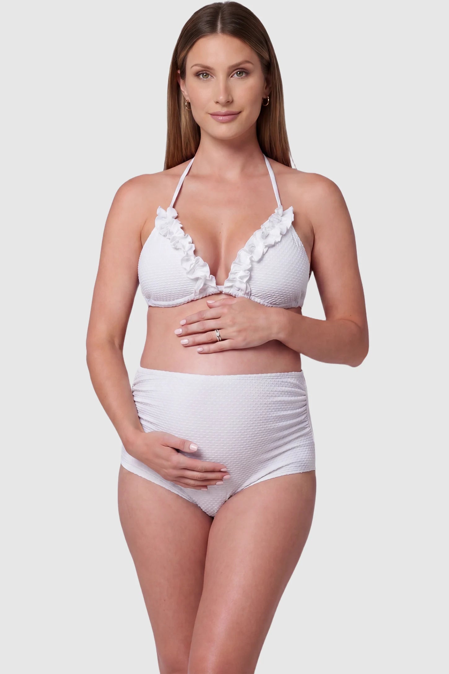 Ruffled Trim Halter Maternity Bikini Set Ruffled trim halter maternity bikini set in white with halter neckline, ruffle detail, and high-waist fit, front view on pregnant model