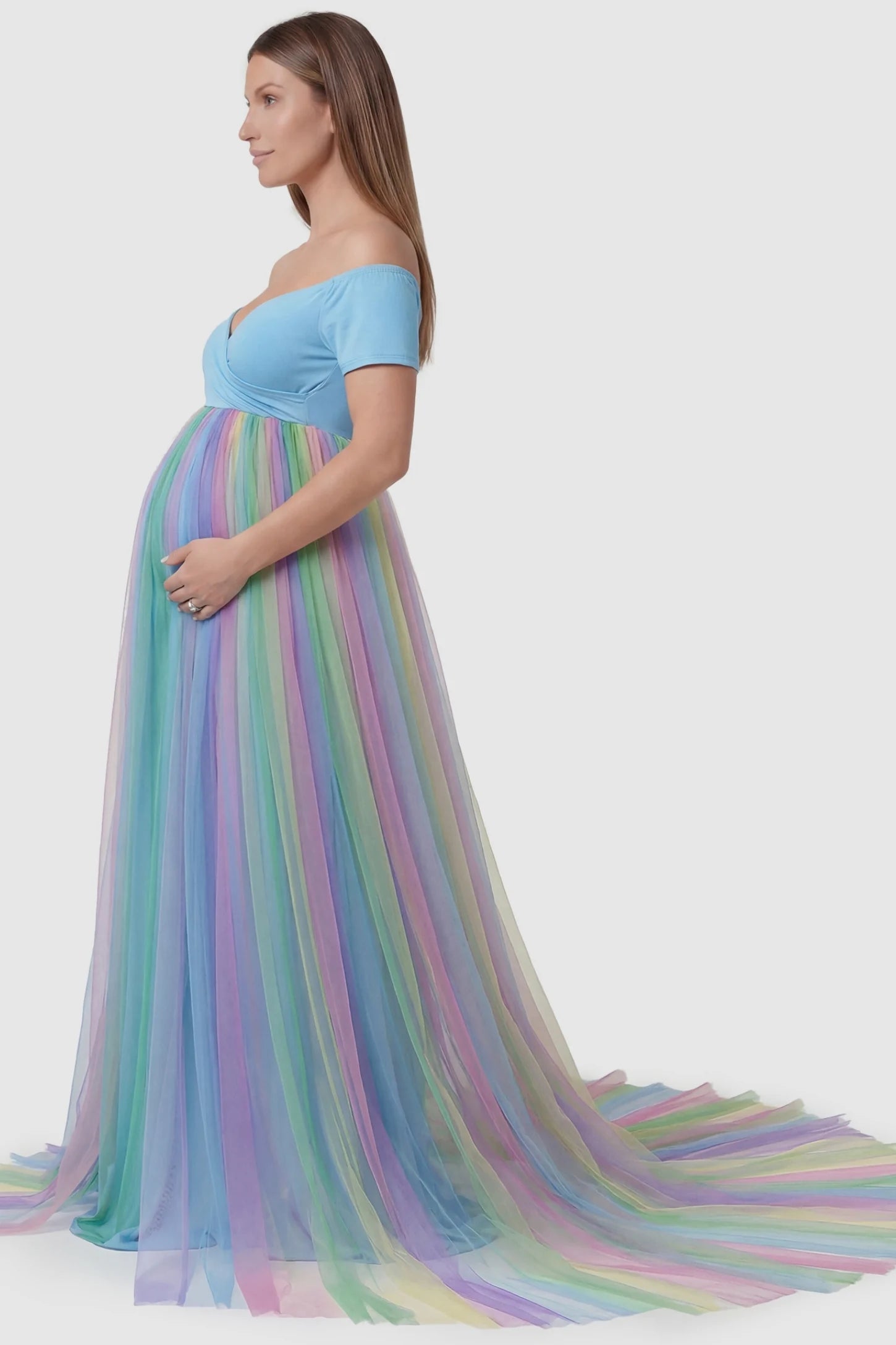 Ruffled Tulle Off-Shoulder Maternity Photoshoot Dress Ruffled Tulle Off-Shoulder Maternity Photoshoot Dress in Sky Blue showing the ruffled trailing skirt on a pregnant model in side view.