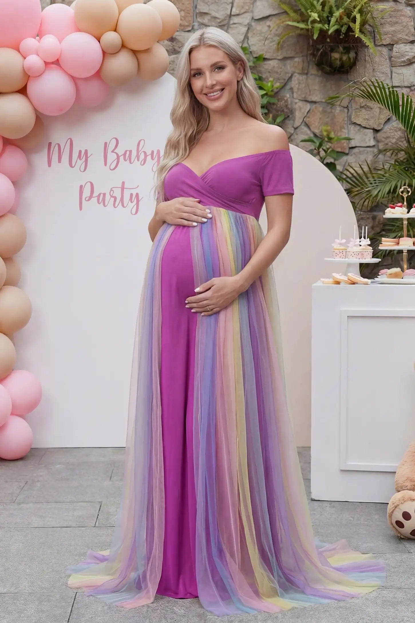 Ruffled Tulle Off-Shoulder Maternity Photoshoot Dress Ruffled Tulle Off-Shoulder Maternity Photoshoot Dress in Violet featuring a multi-color trailing skirt on a pregnant model.