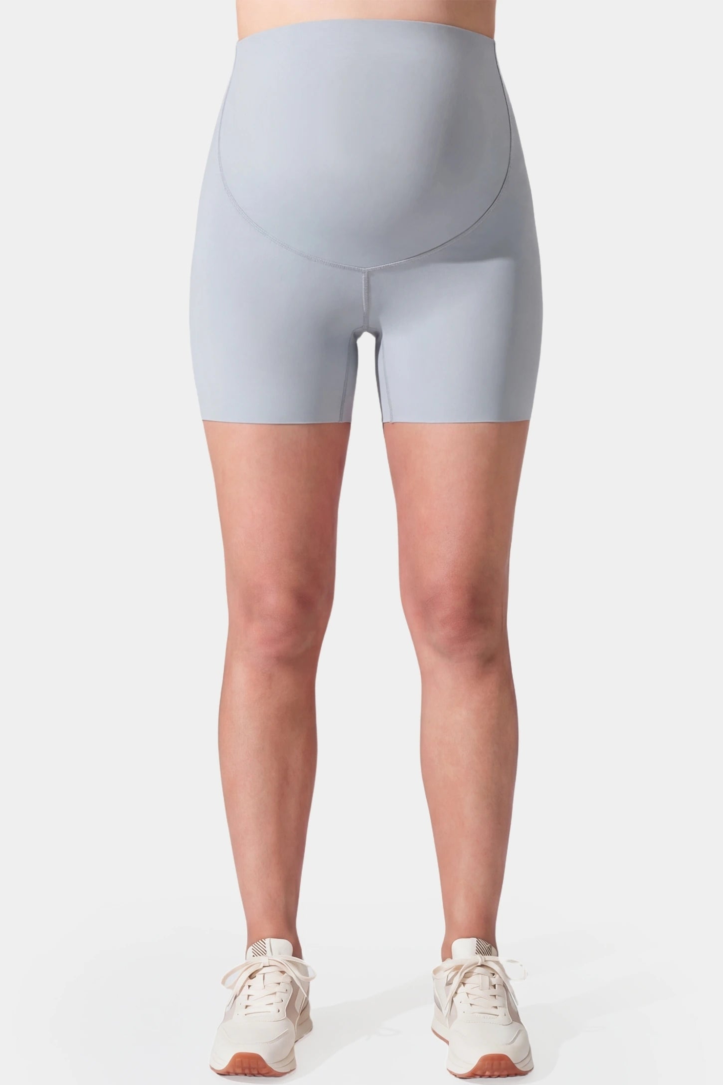 Seamless High-Waist Slim-fit Safety Maternity Shorts Seamless high-waist slim-fit maternity shorts in light gray with tummy support, front view on pregnant model