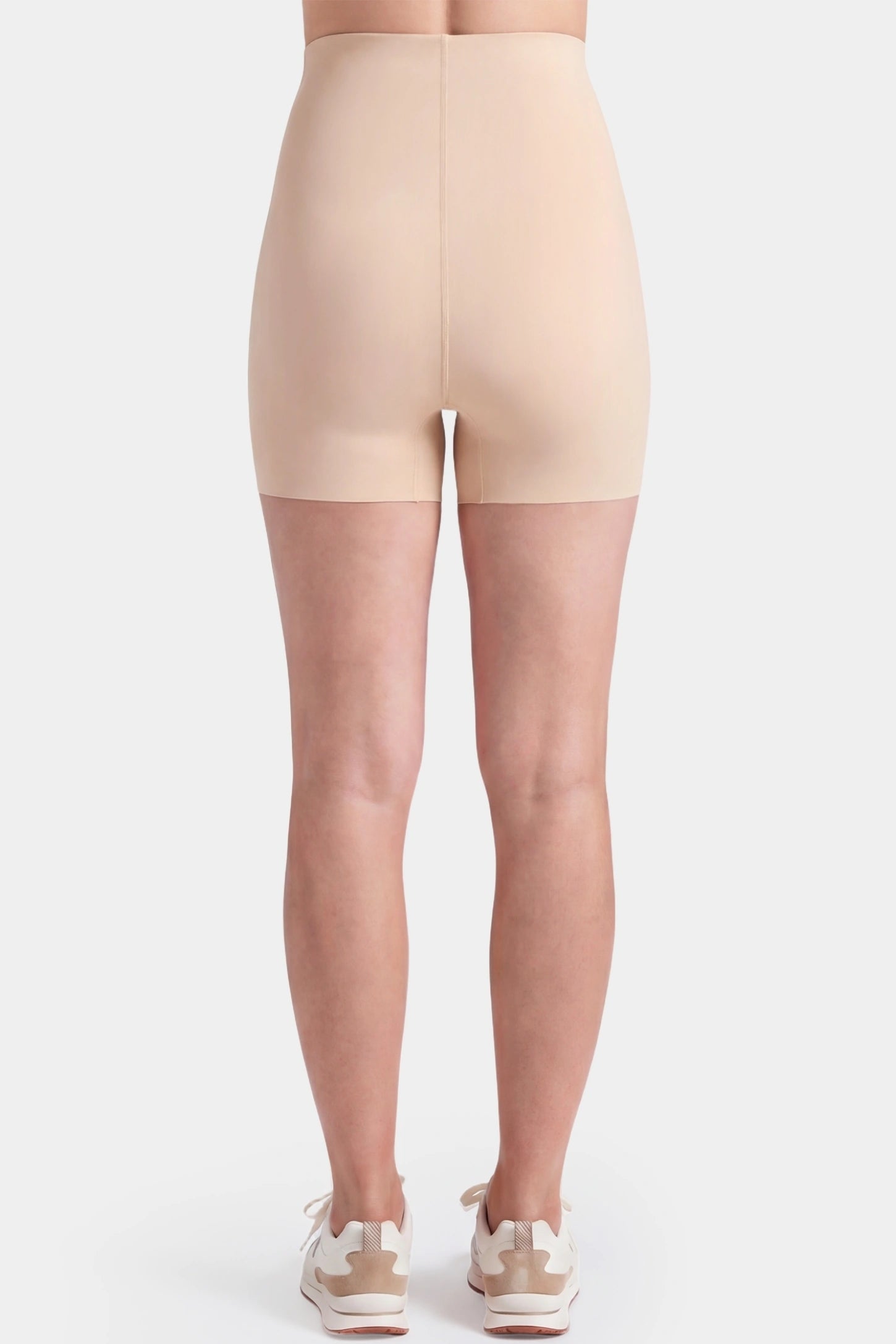 Seamless High-Waist Slim-fit Safety Maternity Shorts Seamless high-waist slim-fit maternity shorts in skin tone with smooth rear contour, back view on pregnant model