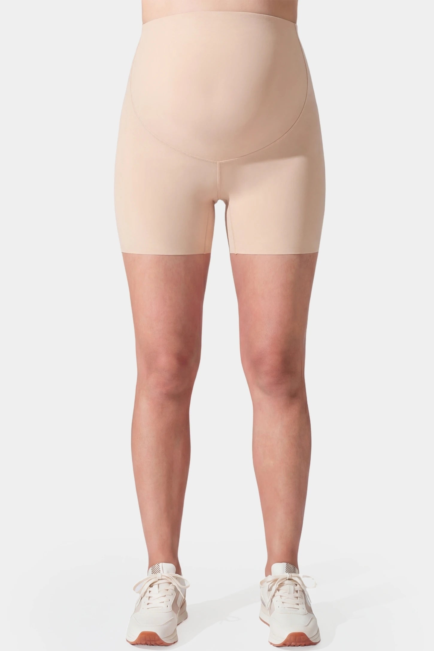 Seamless High-Waist Slim-fit Safety Maternity Shorts Seamless high-waist slim-fit maternity shorts in skin tone with tummy support, front view on pregnant model