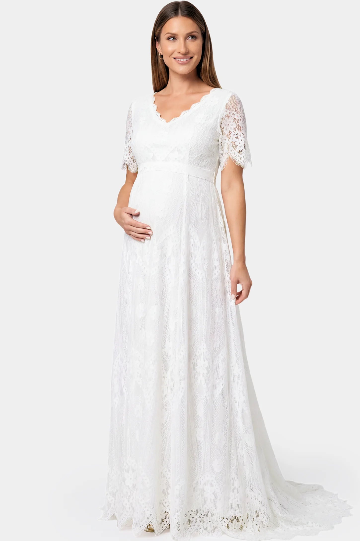Lace Scalloped V-Neck Maternity Gown in white featuring short lace sleeves and scalloped hem on pregnant model.