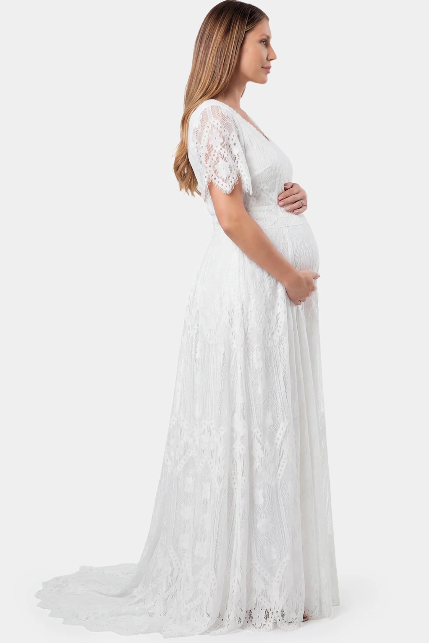 Lace Scalloped V-Neck Maternity Gown in white featuring short lace sleeves and scalloped hem on pregnant model.