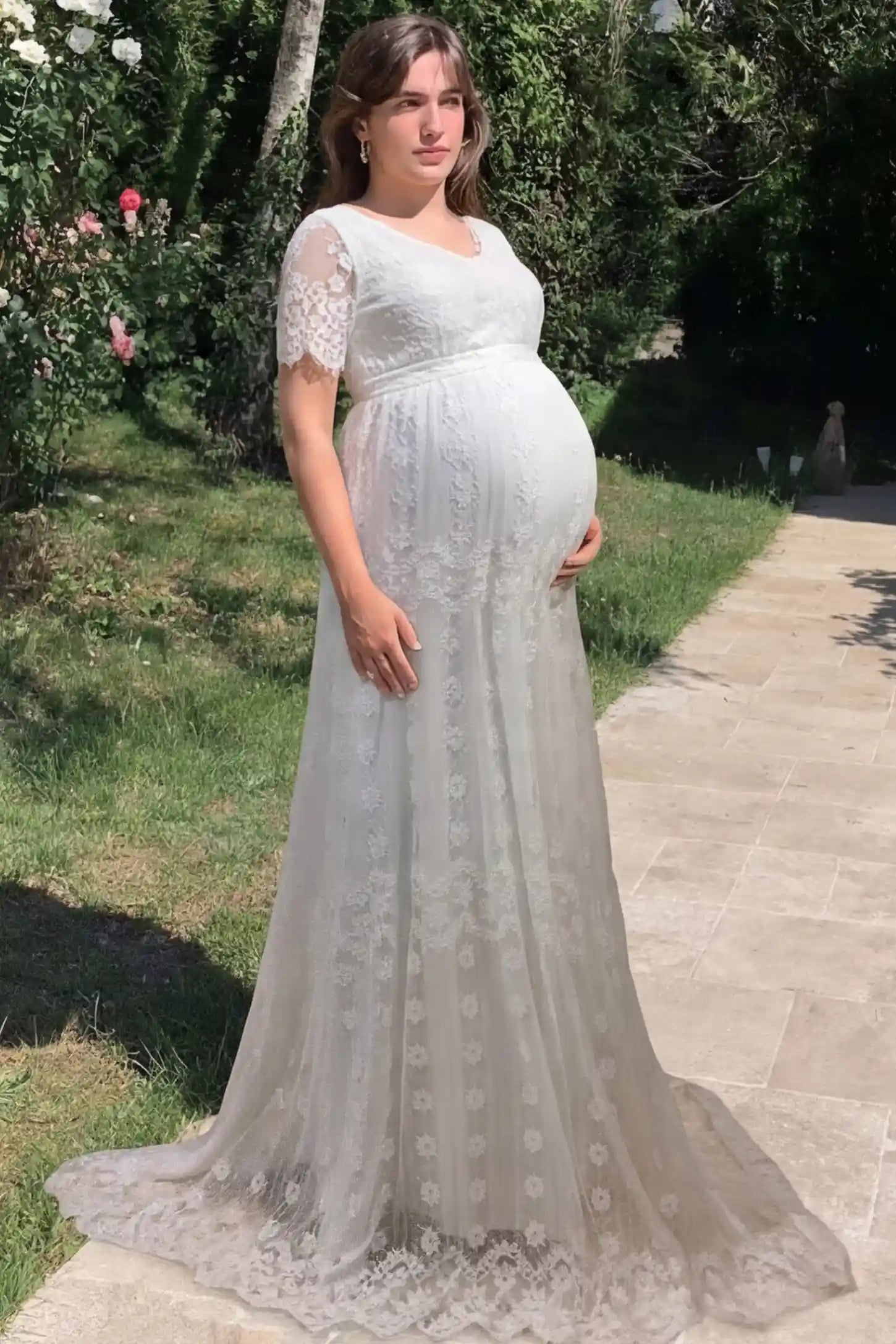 Lace Scalloped V-Neck Maternity Dress Lace Scalloped V-Neck Maternity Gown in white featuring short lace sleeves and scalloped hem on pregnant model.