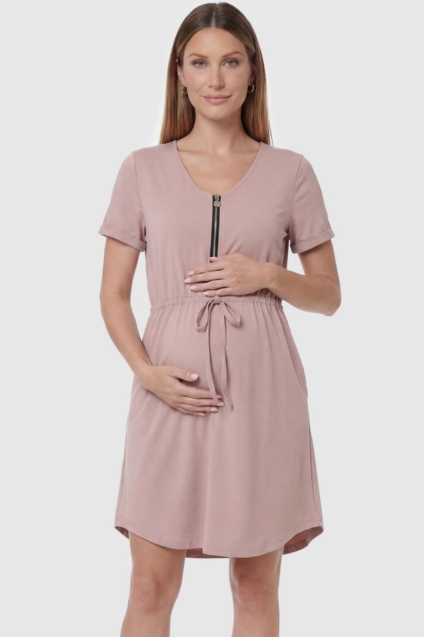 Scoop neck short sleeve maternity and nursing dress in rose gold featuring front zipper closure in front view on a pregnant model