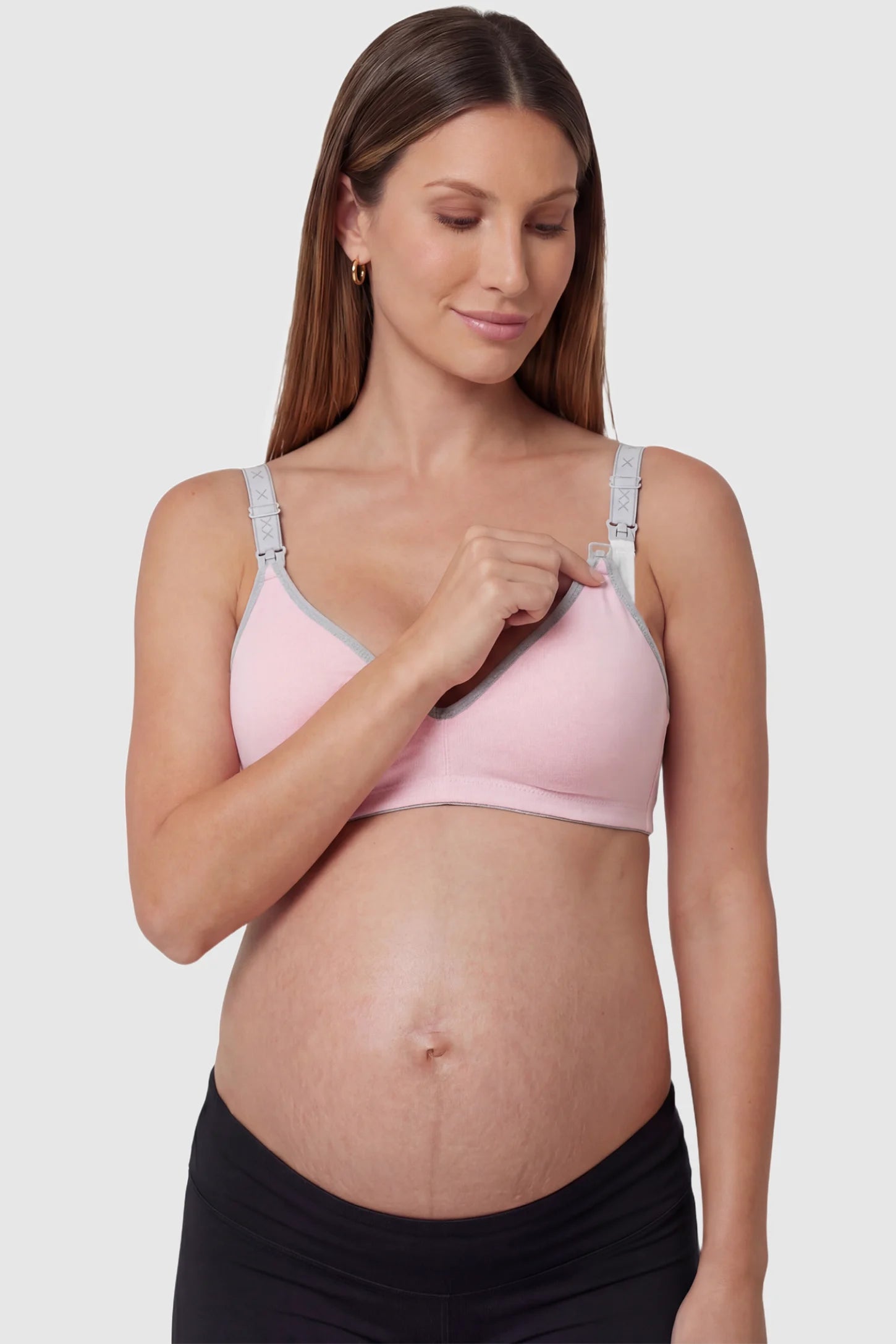 Clip-Down Seamless Nursing Bra Clip-Down Seamless Nursing Bra in pink featuring soft V-neck shape, full-cup coverage, and one-hand nursing clips on pregnant model.