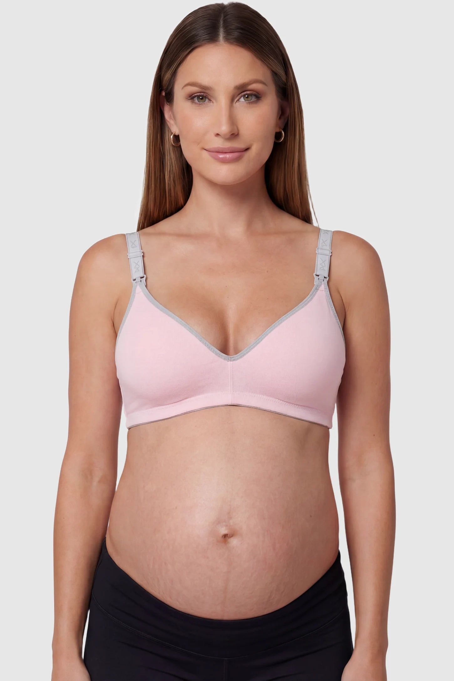 Clip-Down Seamless Nursing Bra Clip-Down Seamless Nursing Bra in pink featuring soft V-neck shape, and full-cup coverage on pregnant model.