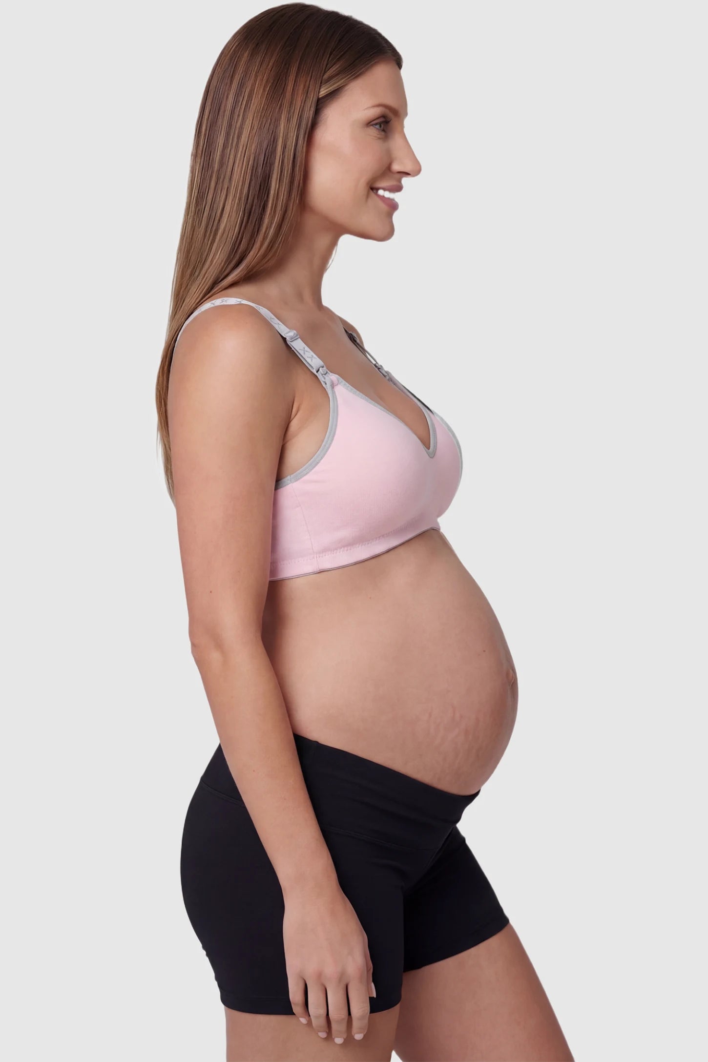 Clip-Down Seamless Nursing Bra Clip-Down Seamless Nursing Bra in pink featuring soft V-neck shape, and full-cup coverage on pregnant model.