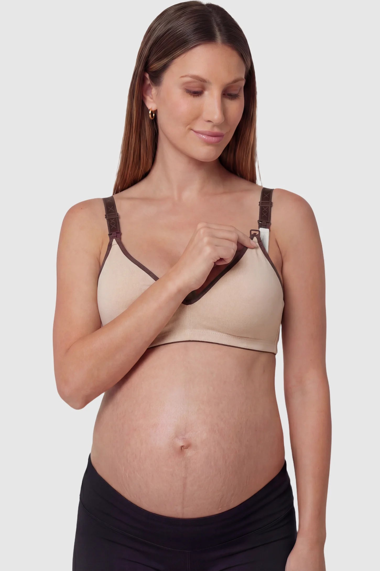 Clip-Down Seamless Nursing Bra Clip-Down Seamless Nursing Bra in skin tone featuring soft V-neck shape, full-cup coverage, and one-hand nursing clips on pregnant model.