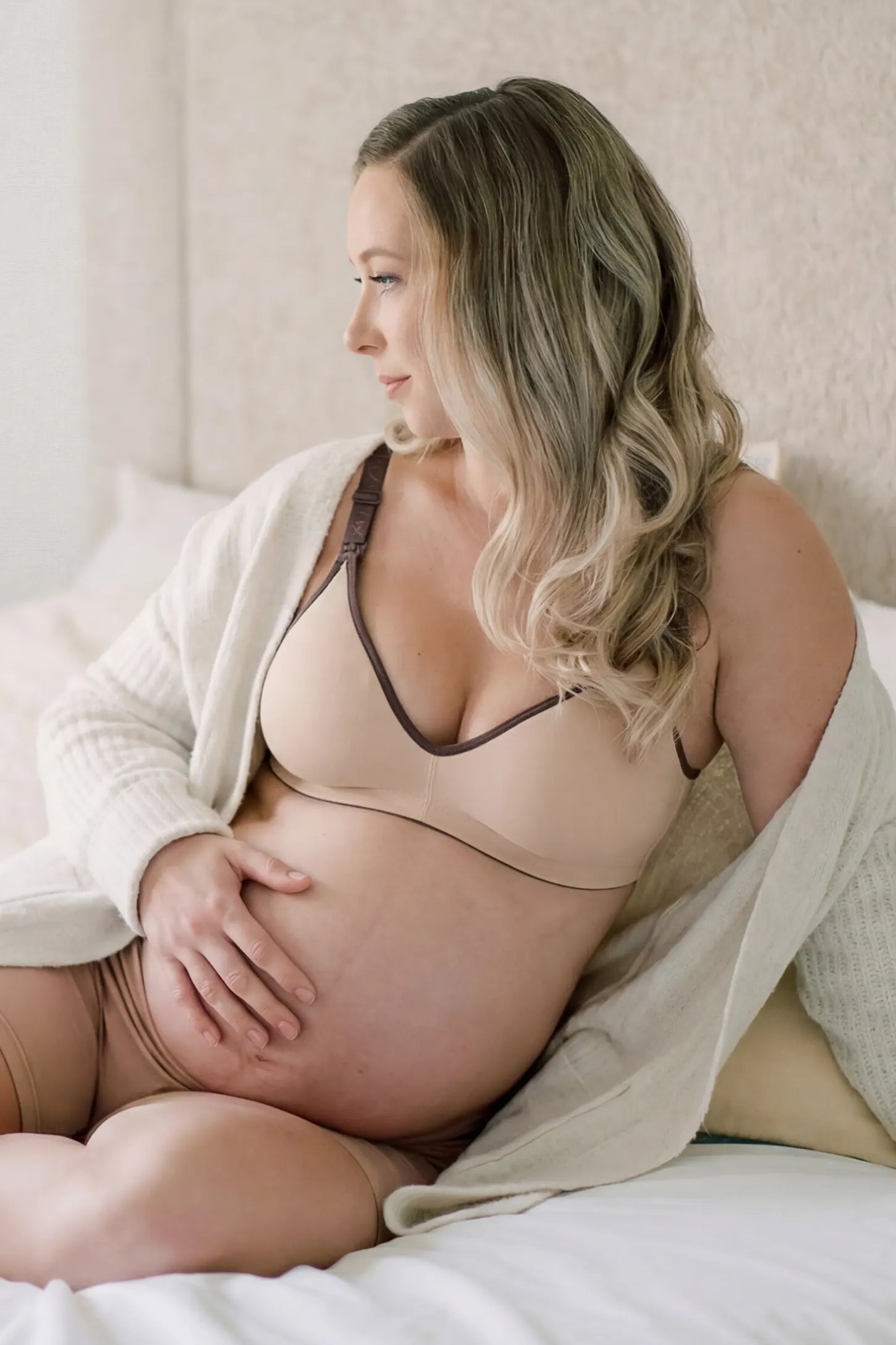 Clip-Down Seamless Nursing Bra Clip-Down Seamless Nursing Bra in skin tone featuring soft V-neck shape, and full-cup coverage on pregnant model.