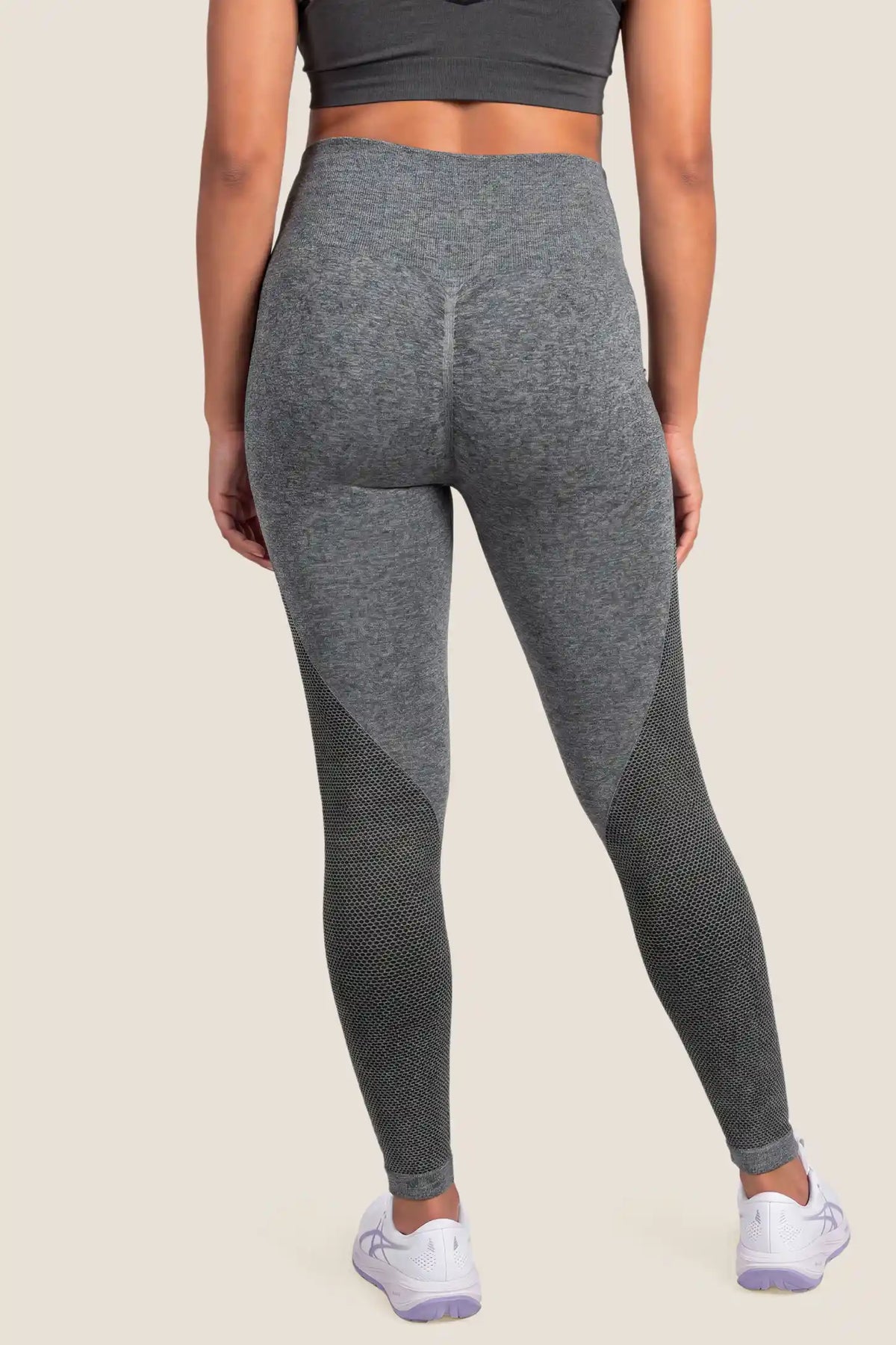 Seamless Over-the-Bump Maternity Leggings Seamless Over-the-Bump Maternity Leggings in Grey featuring sculpting hip & thigh contour, gentle lumbar pressure relief, full back coverage, and seamless anti-chafing comfort on a pregnant model, back view.