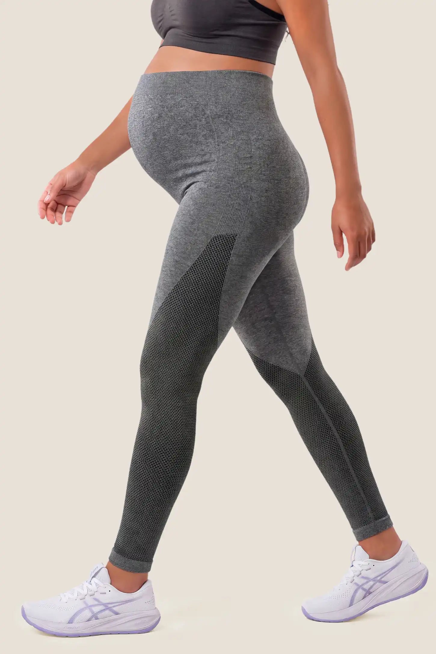 Seamless Over-the-Bump Maternity Leggings in Grey featuring 360° over-the-bump belly support, sculpting hip & thigh contour, and gentle lumbar pressure relief on a pregnant model, side profile view.