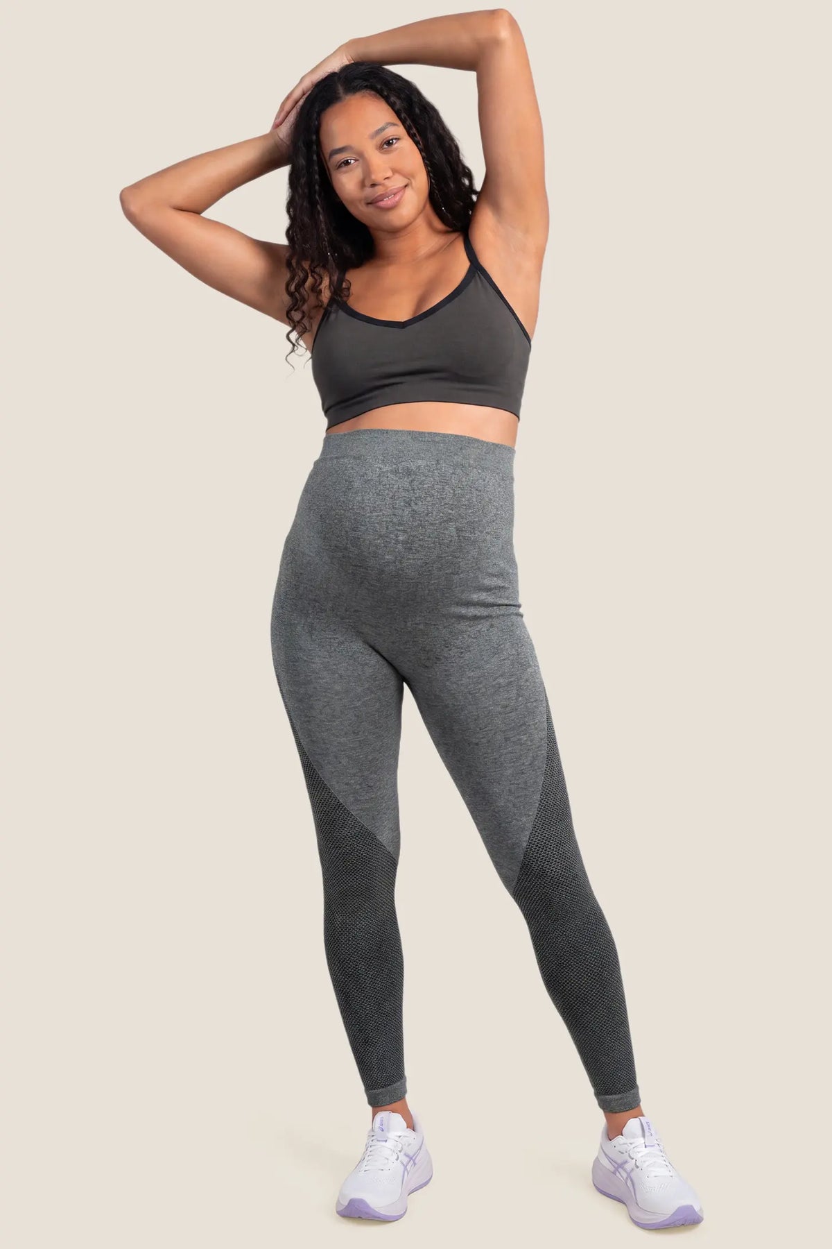 Seamless Over-the-Bump Maternity Leggings Seamless Over-the-Bump Maternity Leggings in Grey featuring full panel belly support, flexible movement support, and body-hugging contour fit on a pregnant model, full-body standing view.